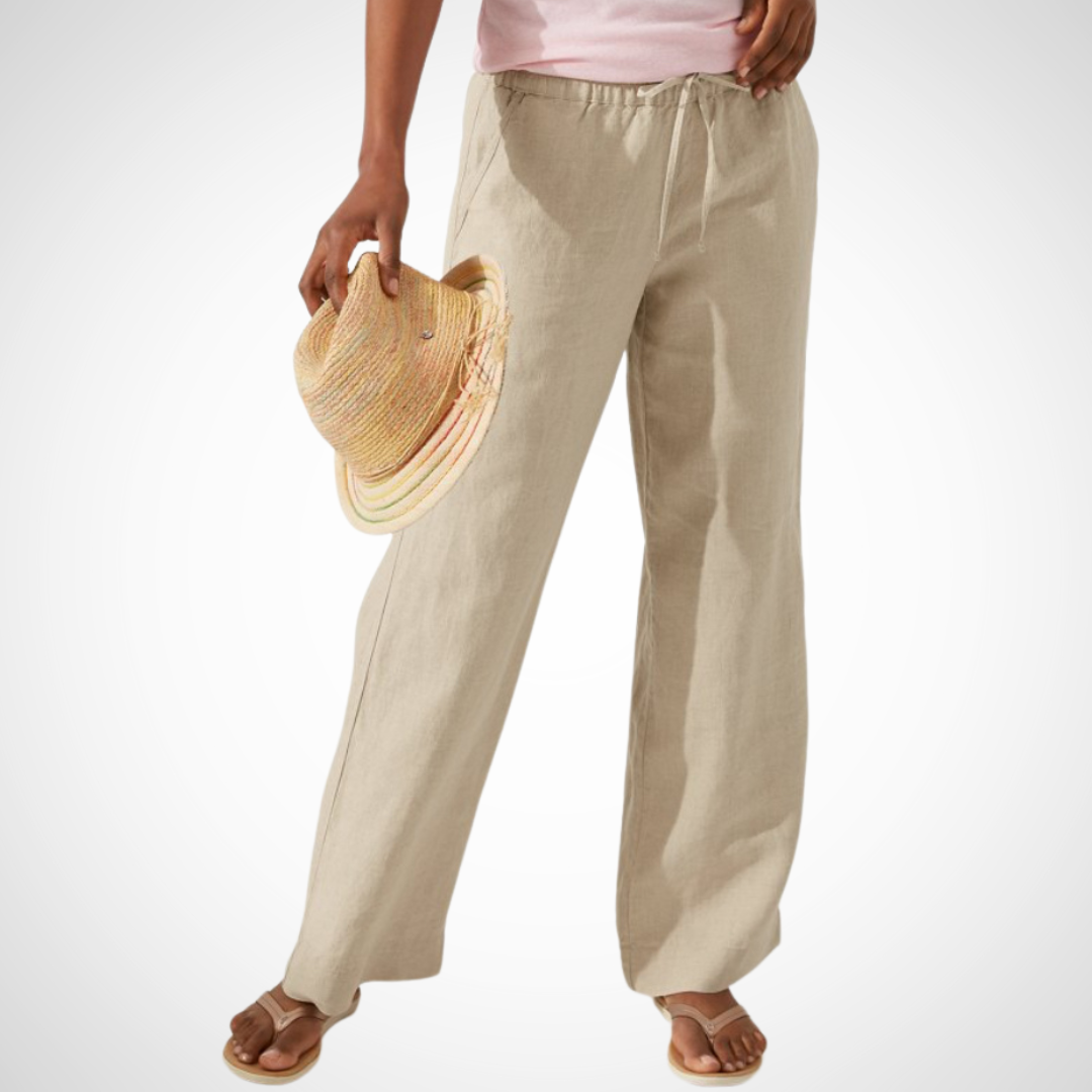 Pearls Boutique Port Dover Ontario - Tommy Bahama - Two Palms Easy Pant. perfect for comfort and style. Ideal for lounging oceanside or socializing with friends. Made from 100% linen for a breathable feel. Features an inseam of 31 inches and an elastic waistband with a drawstring for a customizable fit. Includes front pockets for added convenience. Designed to be an easy fit; consider ordering a size down for a less generous fit. Colour Natural