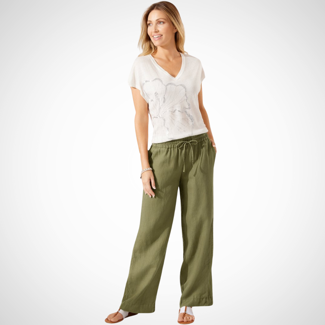 Pearls Boutique Port Dover Ontario - Tommy Bahama - Two Palms Easy Pant. perfect for comfort and style. Ideal for lounging oceanside or socializing with friends. Made from 100% linen for a breathable feel. Features an inseam of 31 inches and an elastic waistband with a drawstring for a customizable fit. Includes front pockets for added convenience. Designed to be an easy fit; consider ordering a size down for a less generous fit. Colour Tea Leaf Green