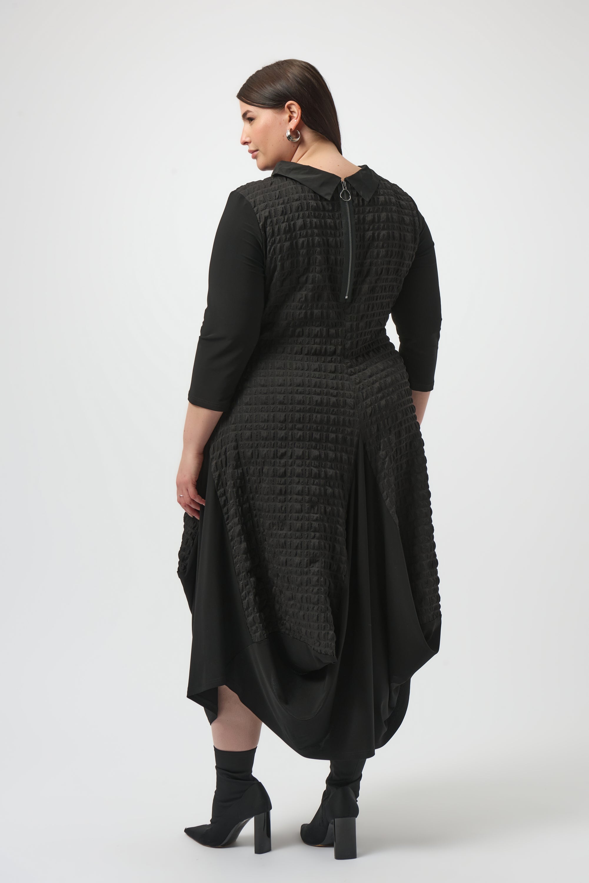 Pearls Boutique| Port Dover Ontario |Joseph Ribkoff | Bubble Jacquard  Silky Knit Cocoon Dress| colour black.
A-line silhouette with a fluid, graceful drape that flatters every movement
Silky knit base with luxe bubble jacquard and memory fabric accents for sculptural texture
Soft cowl neckline adds a touch of understated drama
Three-quarter sleeves designed to balance structure with effortless ease
Functional front pockets for a blend of chic style and everyday practicality
Back zipper closure