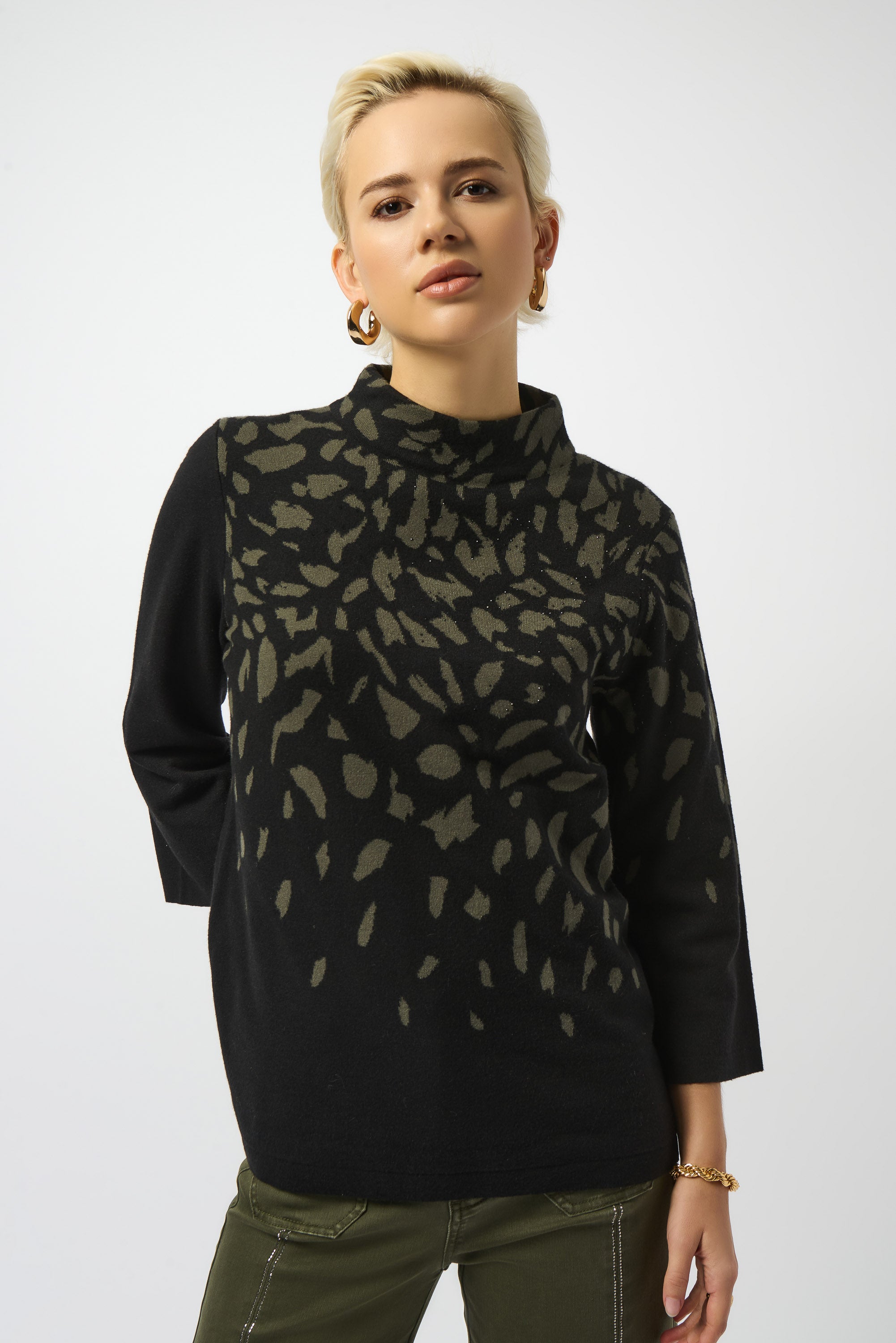 Pearls Boutique | Port Dover Ontario |Joseph Ribkoff |Jacquard Animal Print Sweater. Luxurious jacquard sweater knit with soft, breathable texture
Bold animal print in a dynamic Black/Avocado colourway
Mock neckline for an elevated, cozy silhouette
Three-quarter straight sleeves for a balanced, structured fit
Rhinestone detailing for a refined, touch-of-sparkle finish.