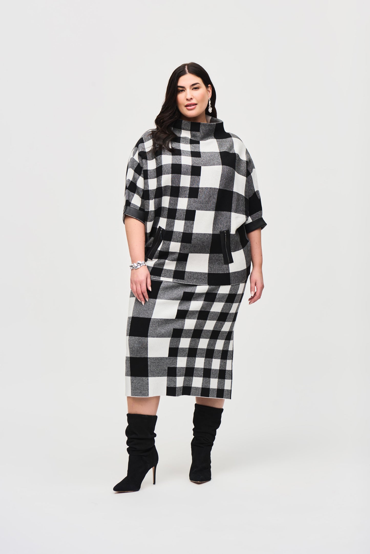 Pearls Boutique - Port Dover Ontario - Joseph Ribkoff - Plaid Jacquard Knit Sweater 243946. Designer: Joseph Ribkoff Style: Chic sweater Neckline: Trendy mock neck Fit: Roomy oversized fit Sleeves: 3/4 straight sleeves Pattern: Charming gingham and marled Detail: Practical zipper Material: 50% Viscose Rayon 28% Nylon 22% Polyester Occasion: Elevates casual wardrobe with comfort and sophistication.Colour Blk/Wht Check 