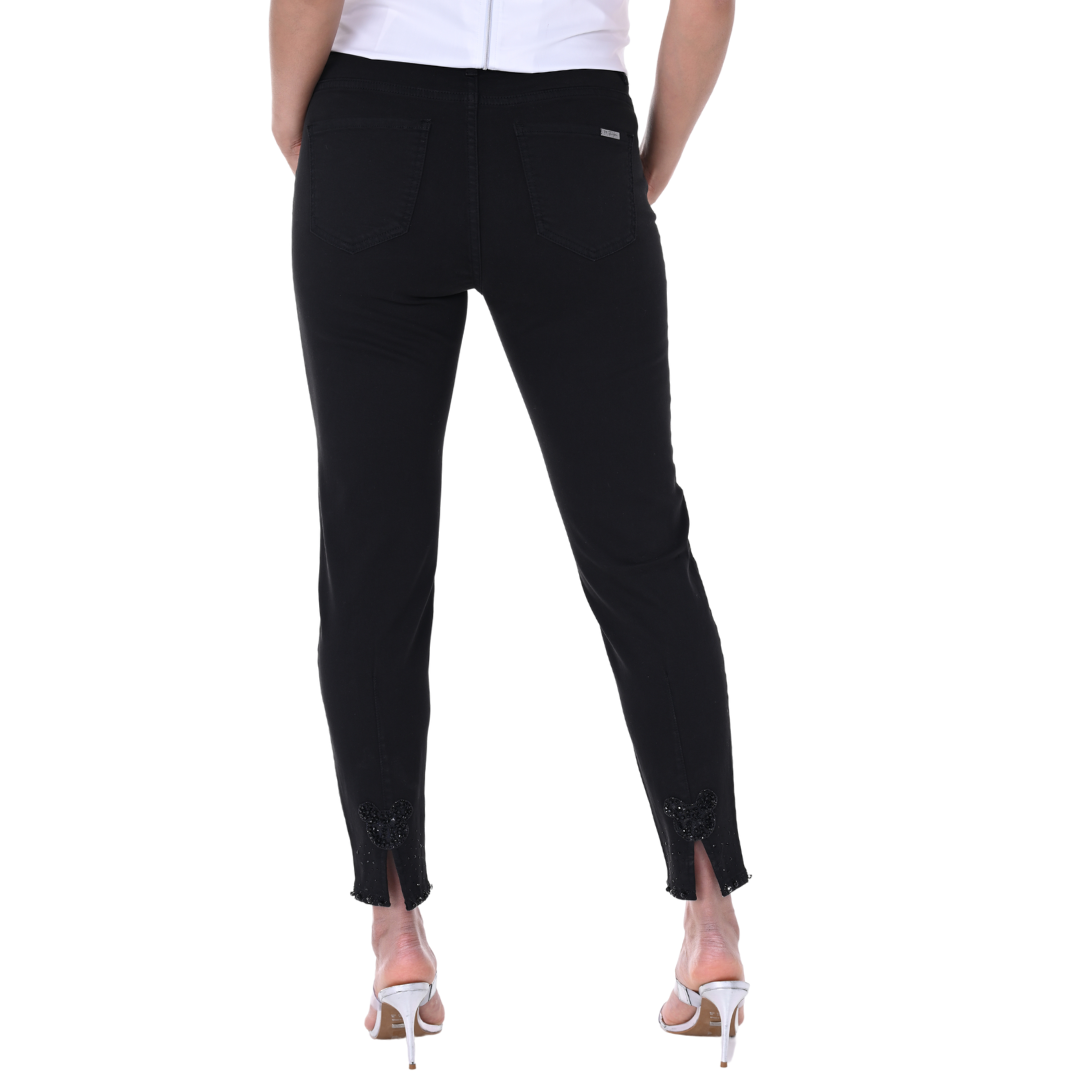 Pearls Boutique - Port Dover Ontario - Frank Lyman Black Denim Pant Ideal for the fashion-forward woman who values whimsical details Features a straight leg, high rise, and chic fly front for a timeless silhouette Hem adorned with rhinestone detailing for a touch of sparkle Back hem boasts a playful Mickey Mouse slit detail for added fun Ankle cut for a perfect blend of sophistication and playfulness A flawless addition to your fashion repertoire.