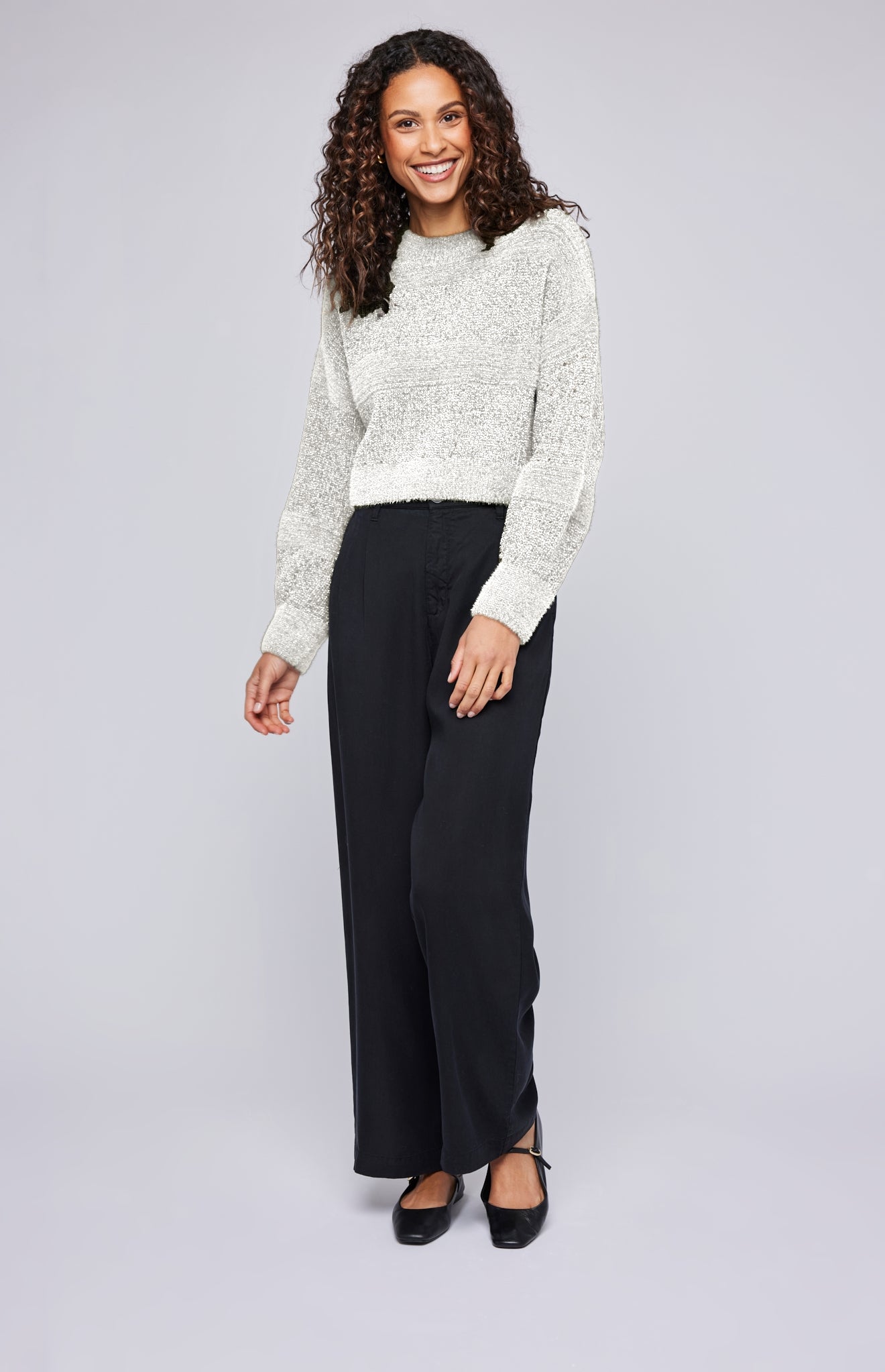 The Rosetta sweater is made of a cozy chenille yarn with a subtle lurex thread throughout. Features include a crew neckline and textured stripe knit pattern.