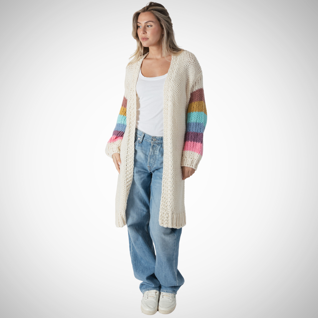 The Shiloh Cardi is a long open front cardigan.  Oat base with multi coloured stripe on balloon sleeve.  100% polyester,  relaxed fit,  knee length  streamlined no pockets  A must have for the cozy Fall season ahead