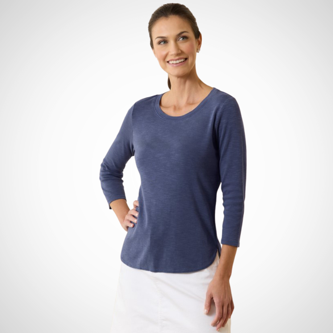 Pearls Boutique Port Dover Ontario - Ashby Isles 3/4 Sleeve Tee - Colour - Navy. Experience the delightful sensation of our soft, micro-rib cotton against your skin, enhanced by its relaxed slubbed texture. The shirt's hem with a stylish tail and ¾-length sleeves further contribute to its laid-back charm. Made entirely of cotton, it is easy to care for—simply machine wash on a gentle cycle and tumble dry on a low setting. Avoid dry cleaning for optimal maintenance.