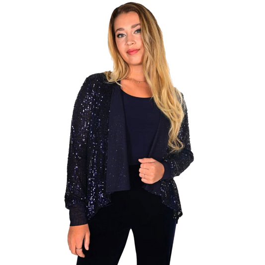 Pearls Boutique - Port Dover Ontario - Frank Lyman - Nacy Sequin Bolero - Open Front, Long Sleeves, Hi-Low Hemline. Midnight is a navy sequin bolero that adds an elegant touch to any look. Its versatile design works with both casual and formal wear, making it a great choice for any event. Its classic construction and shimmering accents give you a refined and glamorous look, while its versatile styling options make it easy to pair with jeans or a special dress. 