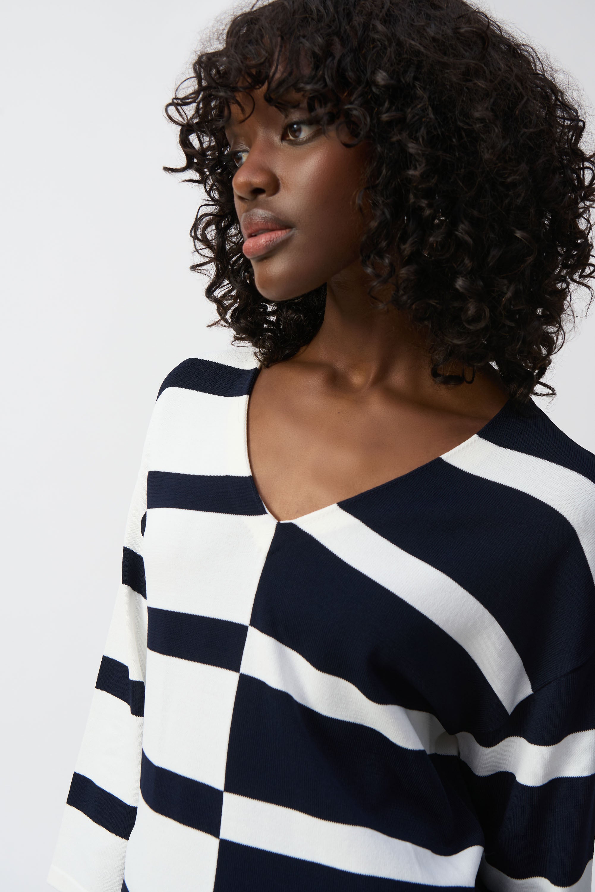 Pearls Boutique-Port Dover-On- Joseph Ribkoff Stripe Top 251914 from the Spring 2025 Collection, featuring a bold geometric stripe design, crafted from 65% Viscose Rayon and 35% Nylon. This Canadian-made top includes a flattering V-neckline, three-quarter sleeves, and versatile styling for both casual and formal occasions. Perfect blend of modern design and luxurious comfort.






