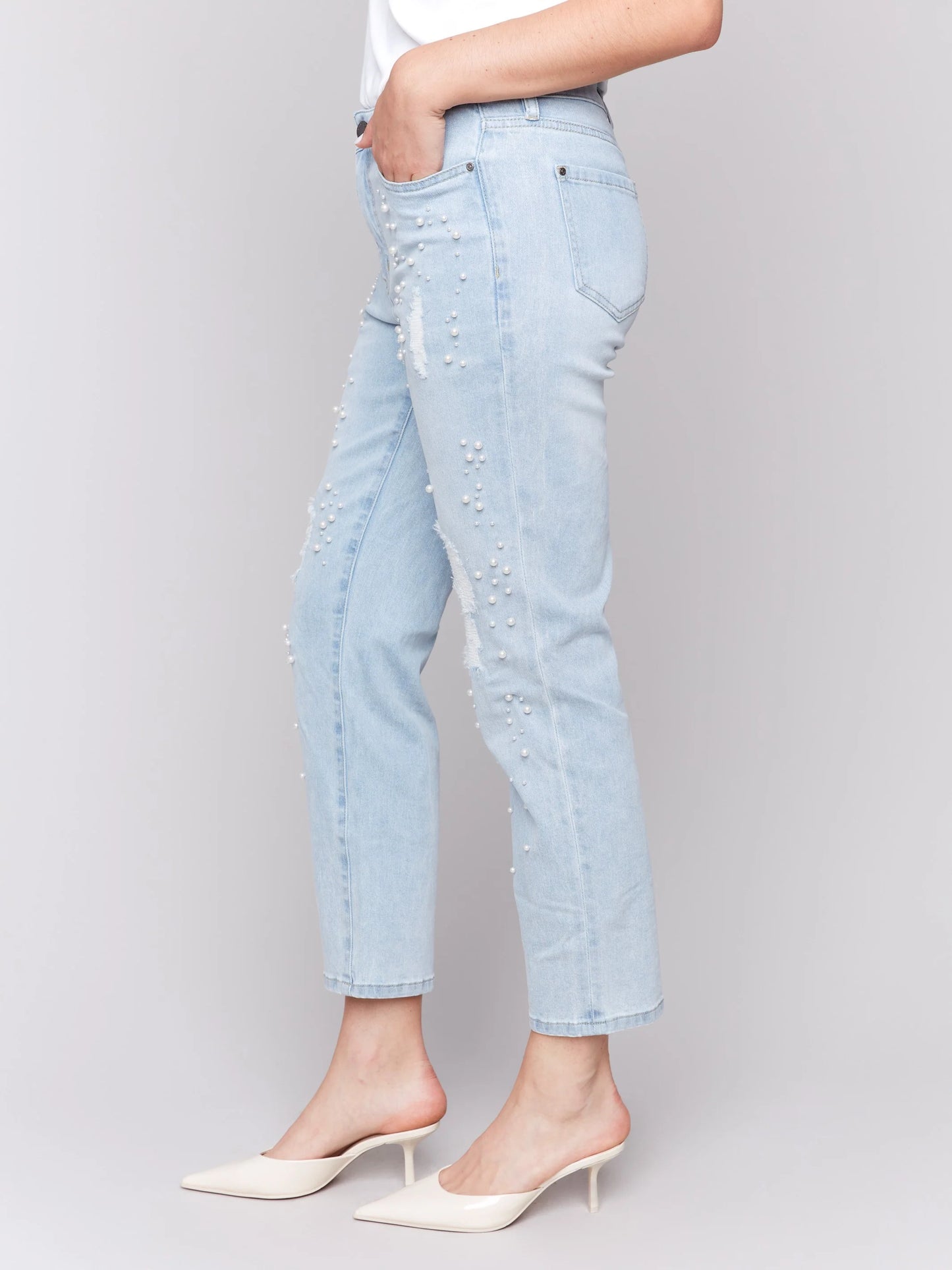 Pearls Boutique-Port Dover Ontario-Charlie B Pearl Applique Slim-Leg Jeans with Distressed Detail-light Blue-Style C5617-301B
Light blue slim-fit jeans with ankle-length cut

Distressed details with delicate pearl appliqué

Regular-rise waist for a flattering fit

Five-pocket design for everyday functionality
Made from stretch denim for comfort and flexibility

Chic blend of elegance and edgy style