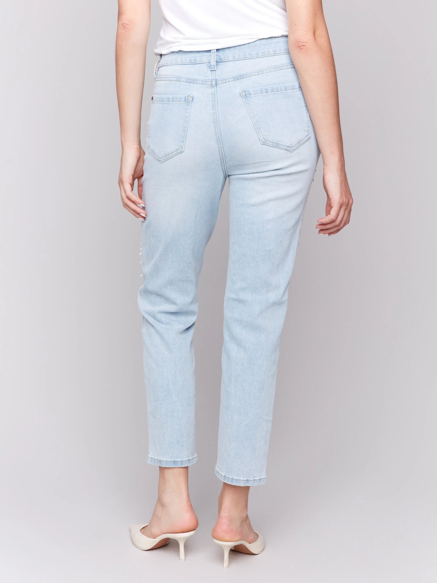 Pearls Boutique-Port Dover Ontario-Charlie B Pearl Applique Slim-Leg Jeans with Distressed Detail-light Blue-Style C5617-301B
Light blue slim-fit jeans with ankle-length cut

Distressed details with delicate pearl appliqué

Regular-rise waist for a flattering fit

Five-pocket design for everyday functionality
Made from stretch denim for comfort and flexibility

Chic blend of elegance and edgy style