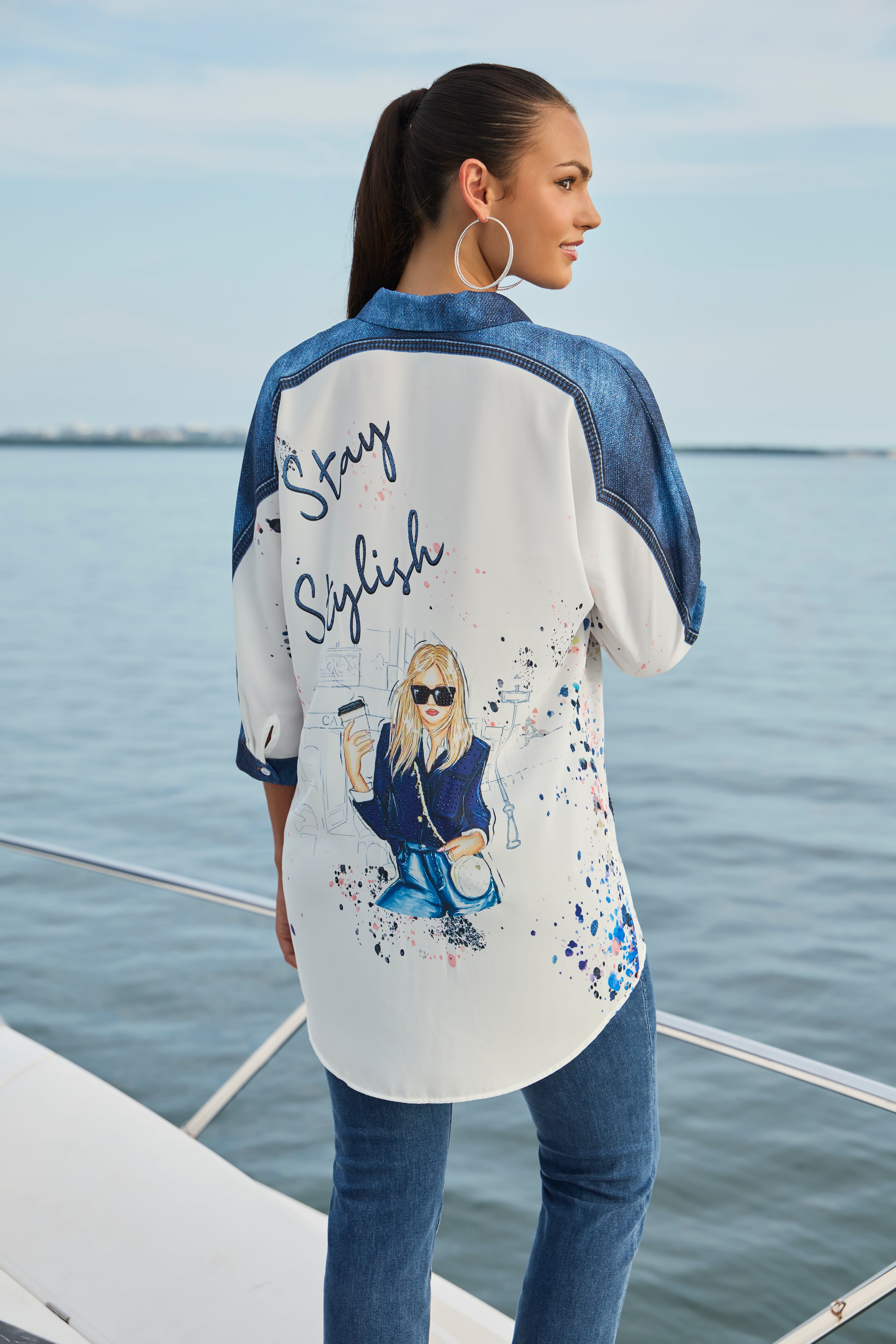 Pearls Boutique-Port Dover Ontario-Frank Lyman Chic & Vivid Blouse (Style 256740U), an off-white woven blouse featuring vibrant multi-colored artistic prints, a button-front design, a breast pocket, a shirt-style collar, and a tunic-length silhouette for a bold and stylish touch to any outfit.