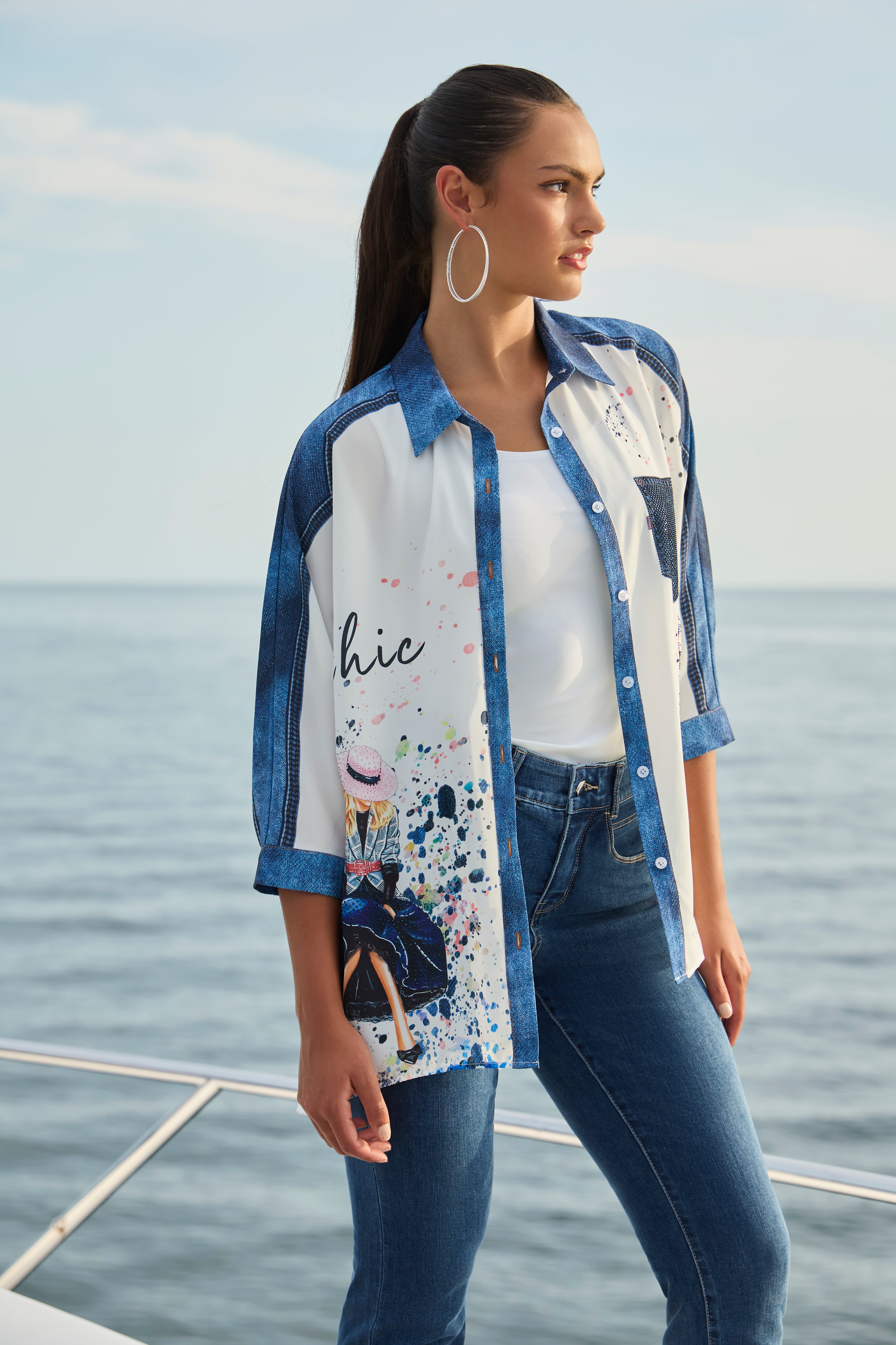 Pearls Boutique-Port Dover Ontario-Frank Lyman Chic & Vivid Blouse (Style 256740U), an off-white woven blouse featuring vibrant multi-colored artistic prints, a button-front design, a breast pocket, a shirt-style collar, and a tunic-length silhouette for a bold and stylish touch to any outfit.