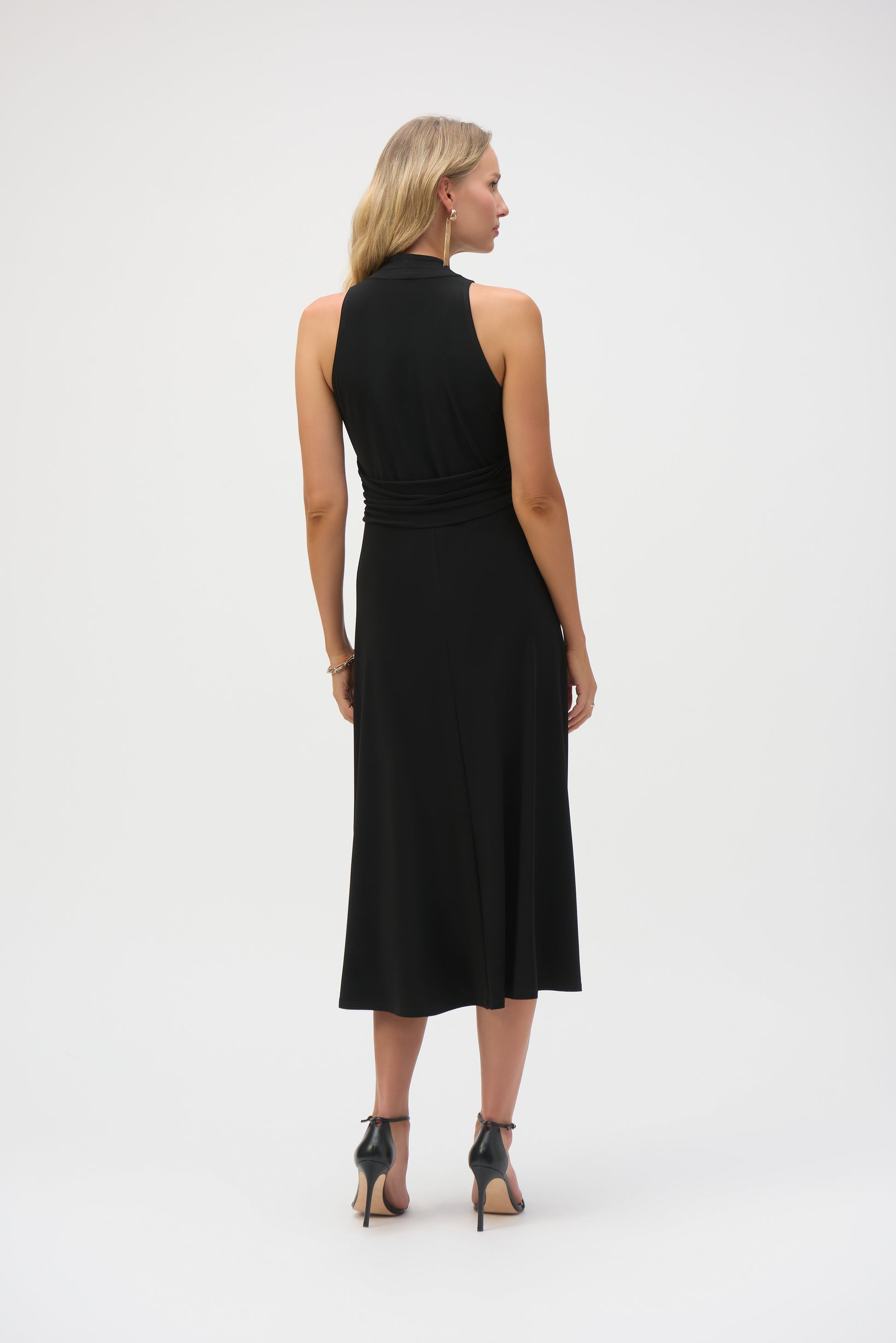 Pearls Boutique-Port Dover Ontario-Joseph Ribkoff - Silky Knit Fit and Flare Dress-252091-11. Black,
A sleek and sophisticated sleeveless midi-length dress crafted from silky knit fabric with stretch. Featuring a flattering V-neckline, chic faux halter design, and a front slit for added elegance. The adjustable waistband accentuates the waistline, while the shirred waist adds shape. Unlined for a lightweight feel. Easy-care fabric.