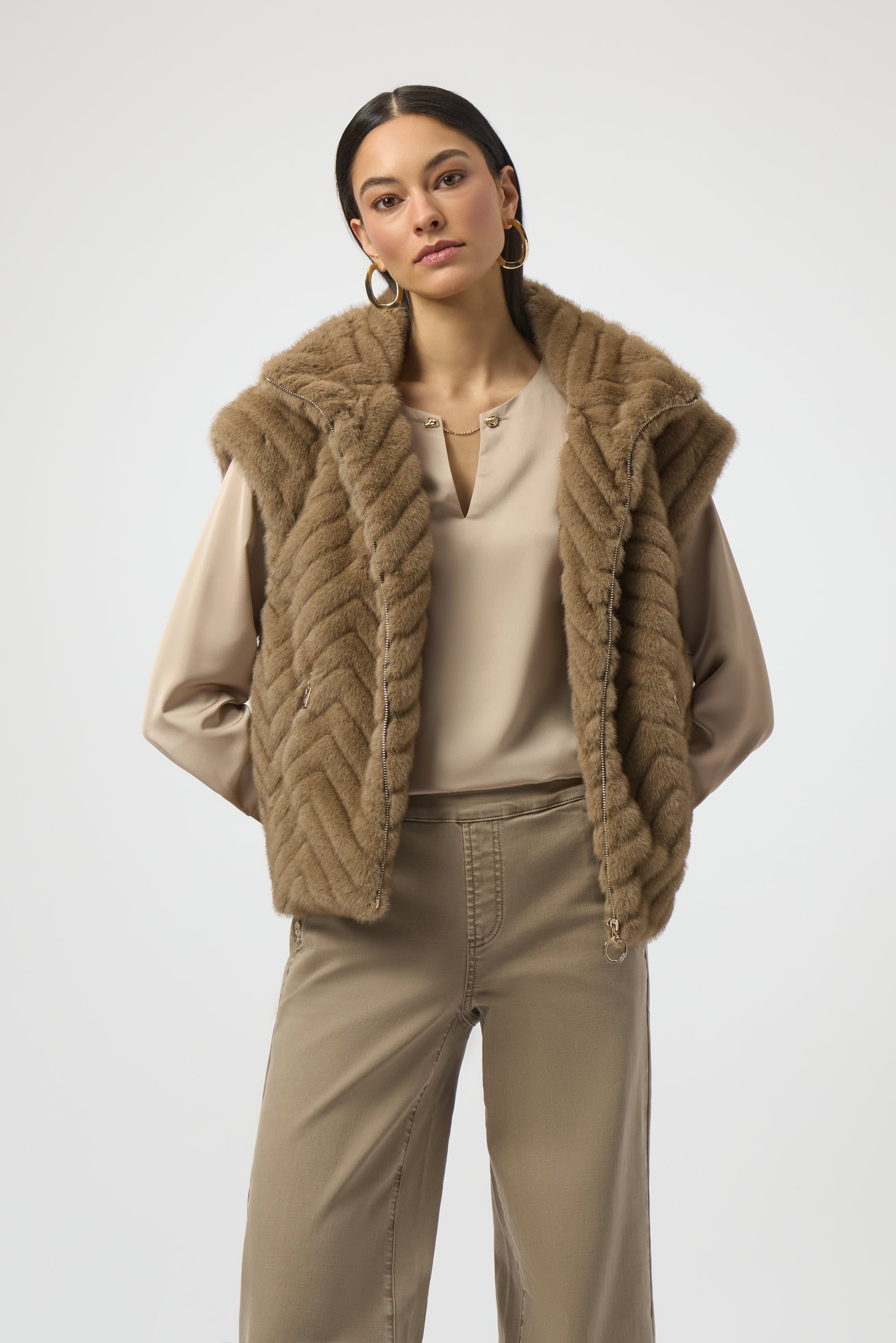 Pearls Boutique-Port Dover Ontario-Joseph Ribkoff |Chevron Faux Fur Mock Neck Vest- colour Mink

Stand out in style with this chic faux fur vest, featuring a striking chevron print for a bold yet sophisticated touch. Designed with a sleek zip-front closure, short capped sleeves, and a refined mock neck, it’s a statement piece that's sure to enhance any outfit.

100% Polyester
Faux fur
Chevron print
Mock collar
Short cap sleeves
Zip front closure
Zip pockets
Lined 