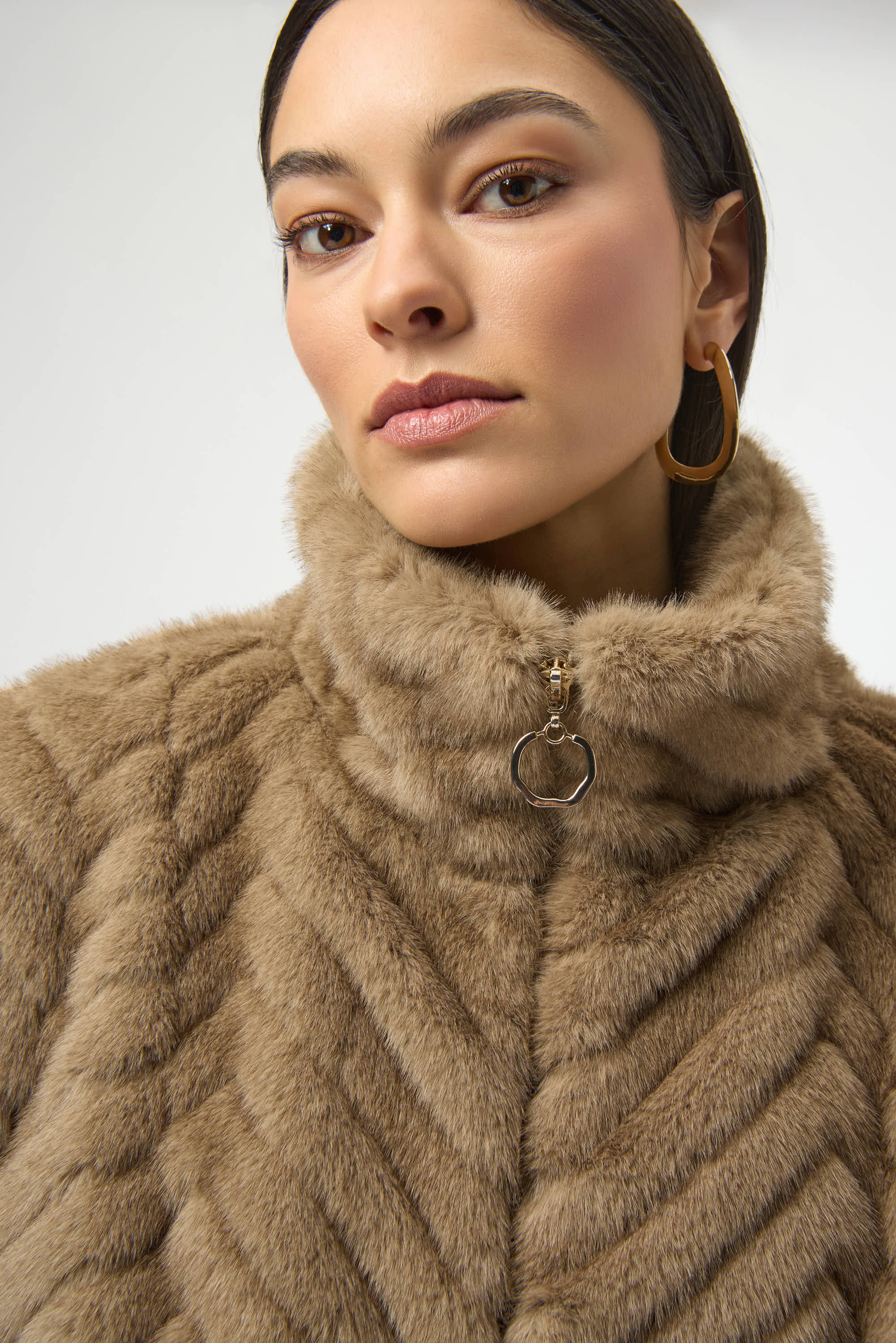 Pearls Boutique-Port Dover Ontario-Joseph Ribkoff |Chevron Faux Fur Mock Neck Vest- colour Mink

Stand out in style with this chic faux fur vest, featuring a striking chevron print for a bold yet sophisticated touch. Designed with a sleek zip-front closure, short capped sleeves, and a refined mock neck, it’s a statement piece that's sure to enhance any outfit.

100% Polyester
Faux fur
Chevron print
Mock collar
Short cap sleeves
Zip front closure
Zip pockets
Lined 