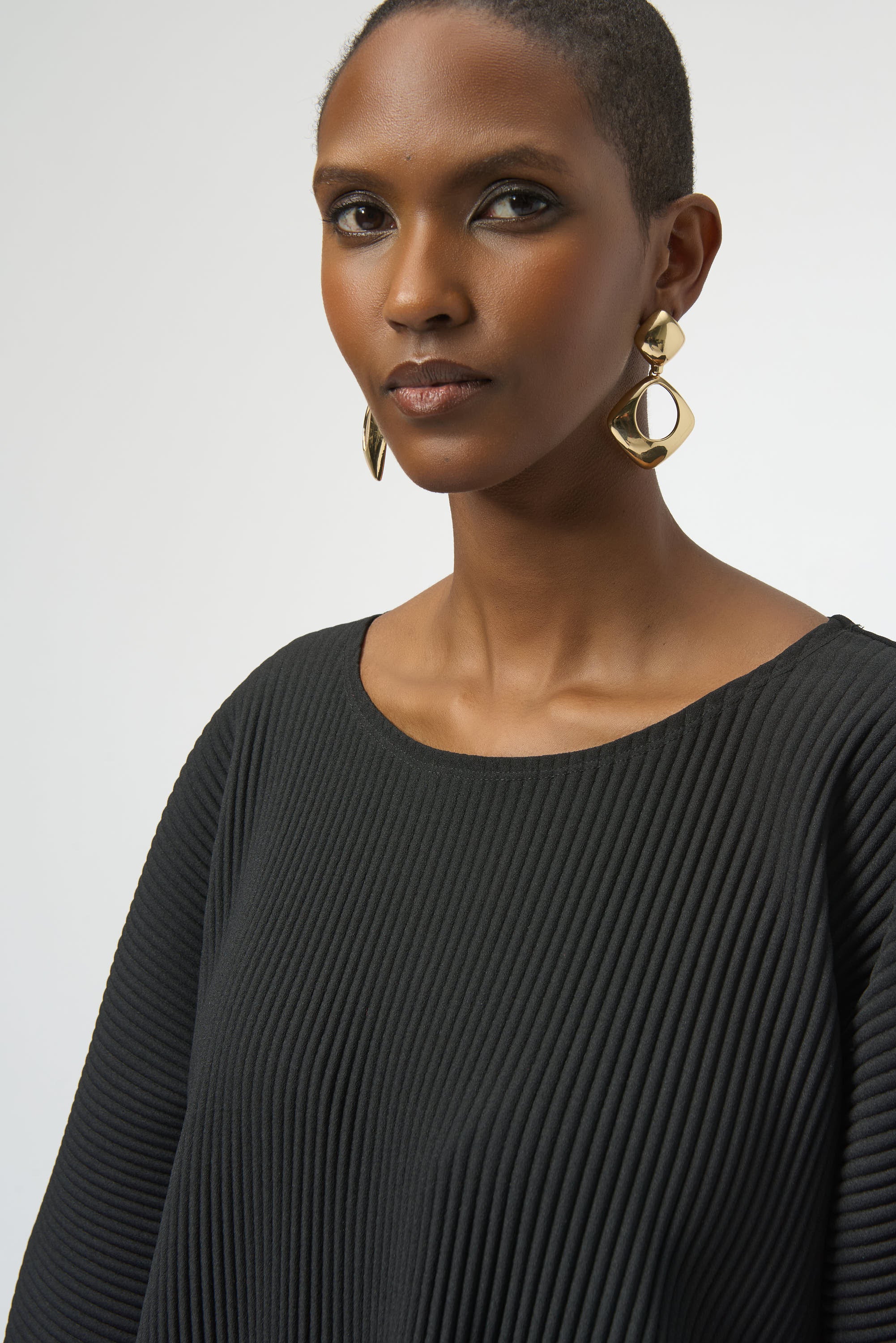 Pearls Boutique-Port Dover Ontario-Joseph Ribkoff | Pleated Scuba Crepe Boxy Top-Colour Black
– Lightweight scuba crepe with subtle structure
– Delicate pleating for added movement and dimension
– Flattering scoop neckline with soft drape
– Three-quarter dolman sleeves for a contemporary finish
– Relaxed, boxy silhouette for all-day comfort