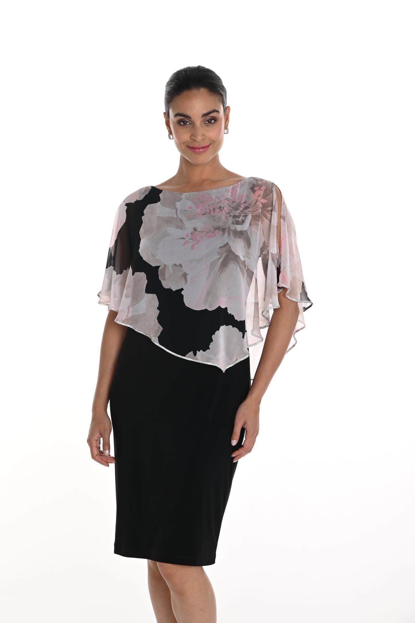 Pearls Boutique-Port Dover Ontario Frank Lyman Knee-Length Dress – Elegant and sophisticated design.
 
Chiffon Cape Overlay – Sheer, flowing fabric drapes over the shoulders.
Floral Print on Cape – Large soft grey and pink flowers with black accents.
Asymmetrical Hem on Cape – Adds movement and a touch of drama.
Boat Neckline –
Short Flutter Sleeves – Light and airy chiffon drapes over arms.
 Trim on Cape Edge has Subtle shimmer Ideal for weddings, parties, or elegant gatherings.






