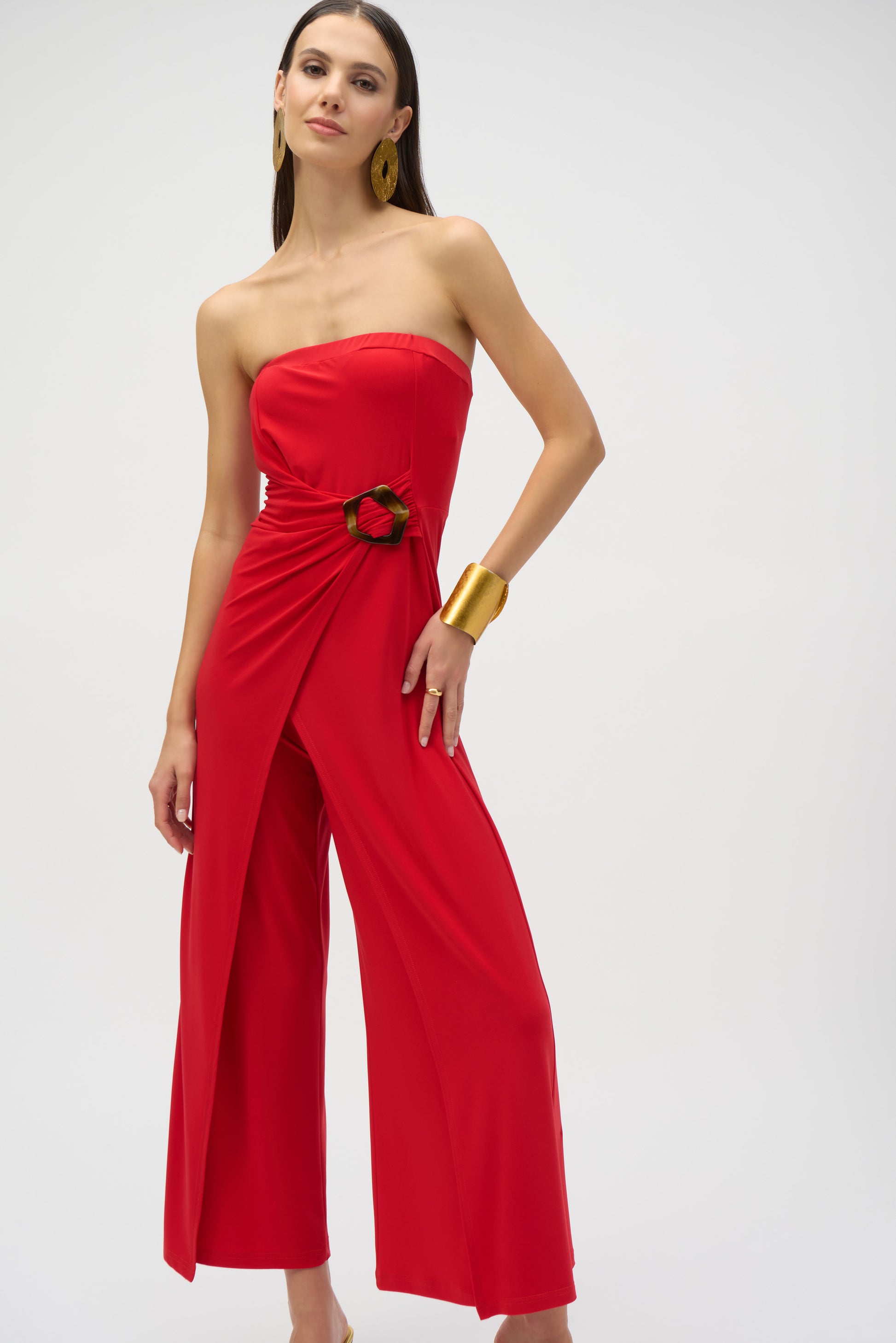 
Pearls Boutique- Port DoverOntario-Joseph Ribkoff- Red silky knit strapless culotte jumpsuit-252083 featuring a bandeau-style bodice with hidden elastic for a perfect fit. Designed with a faux wrap detail and a wide-leg silhouette that adds grace to every movement, the side is elegantly draped and adorned with a faux tortoise shell buckle for a dramatic flair. Unlined for a lightweight feel. Made from 95% polyester and 5% spandex, with easy-care instructions: hand wash, hang to dry, and low iron if needed.
