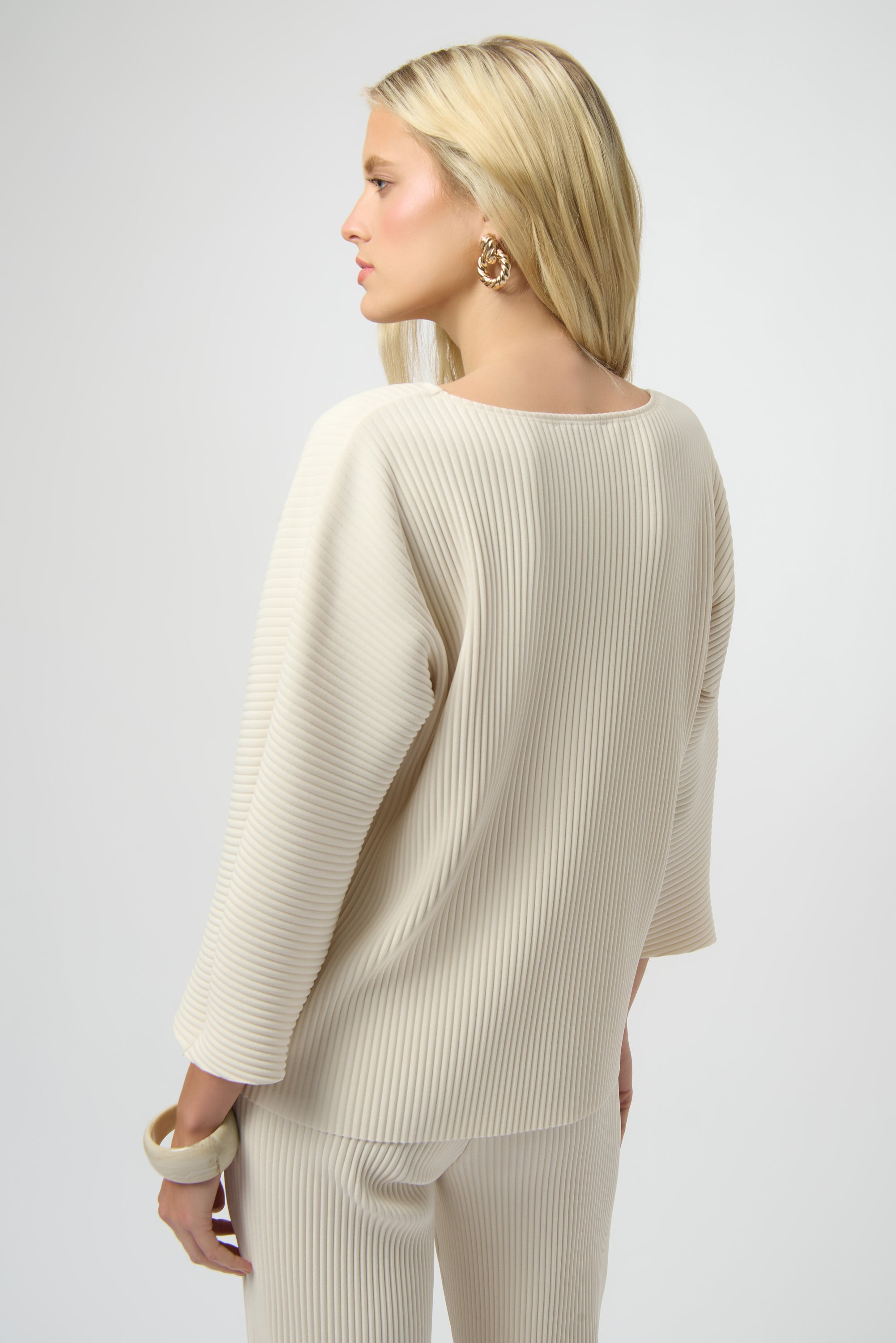 Pearls Boutique-Port Dover Ontario-Joseph Ribkoff | Pleated Scuba Crepe Boxy Top-Colour Birch
– Lightweight scuba crepe with subtle structure
– Delicate pleating for added movement and dimension
– Flattering scoop neckline with soft drape
– Three-quarter dolman sleeves for a contemporary finish
– Relaxed, boxy silhouette for all-day comfort