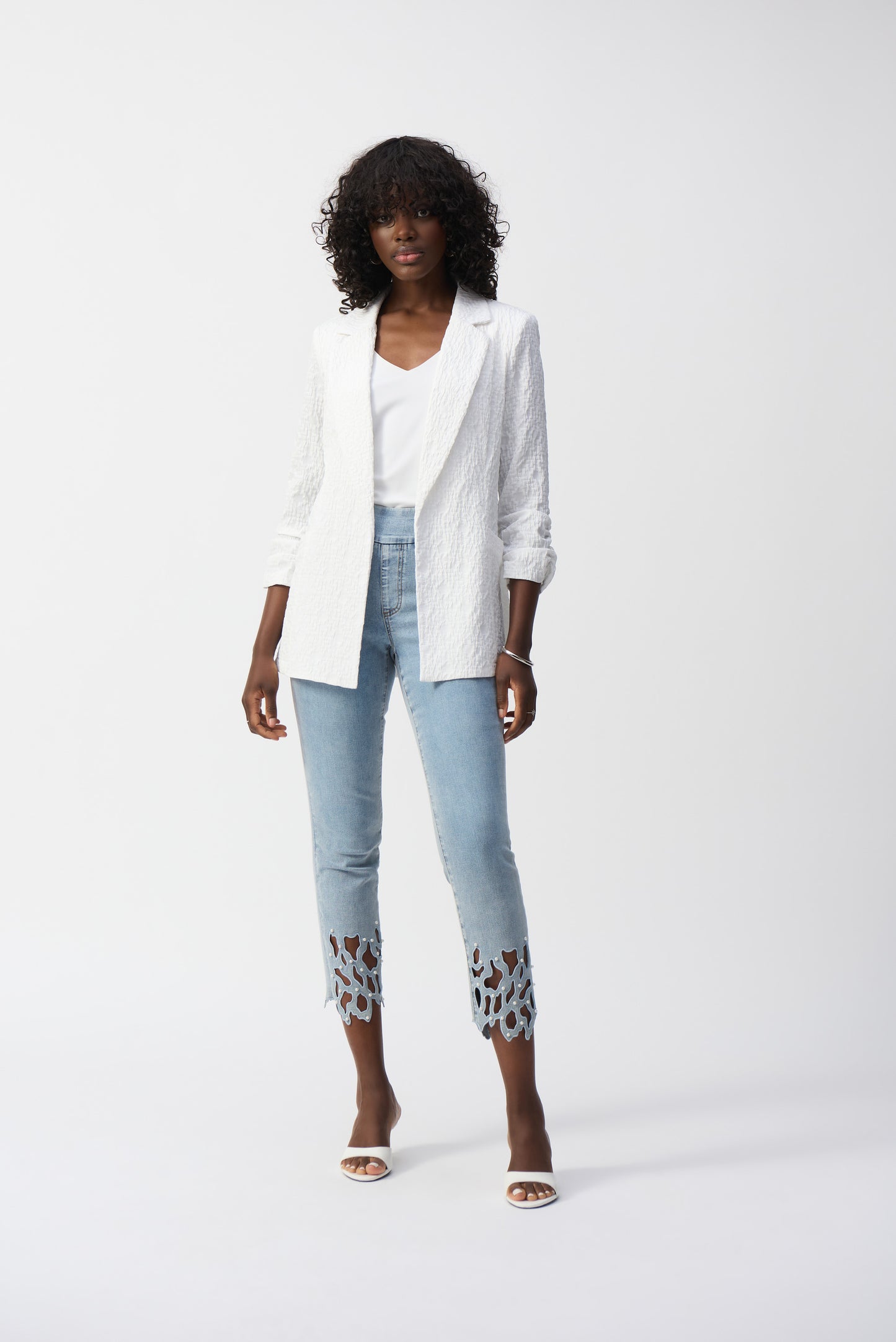 Pearls Boutique- Port Dover Ontario-Joseph Ribkoff White Textured Blazer 242034 Open-front jacket with a polished yet relaxed silhouette for effortless layering, featuring a sophisticated notched lapel for both office and casual wear. Designed with long, straight sleeves for versatile all-season styling. Functional side pockets add practicality without compromising style. Made from a soft, breathable blend of 99% polyester and 1% spandex for all-day comfort.