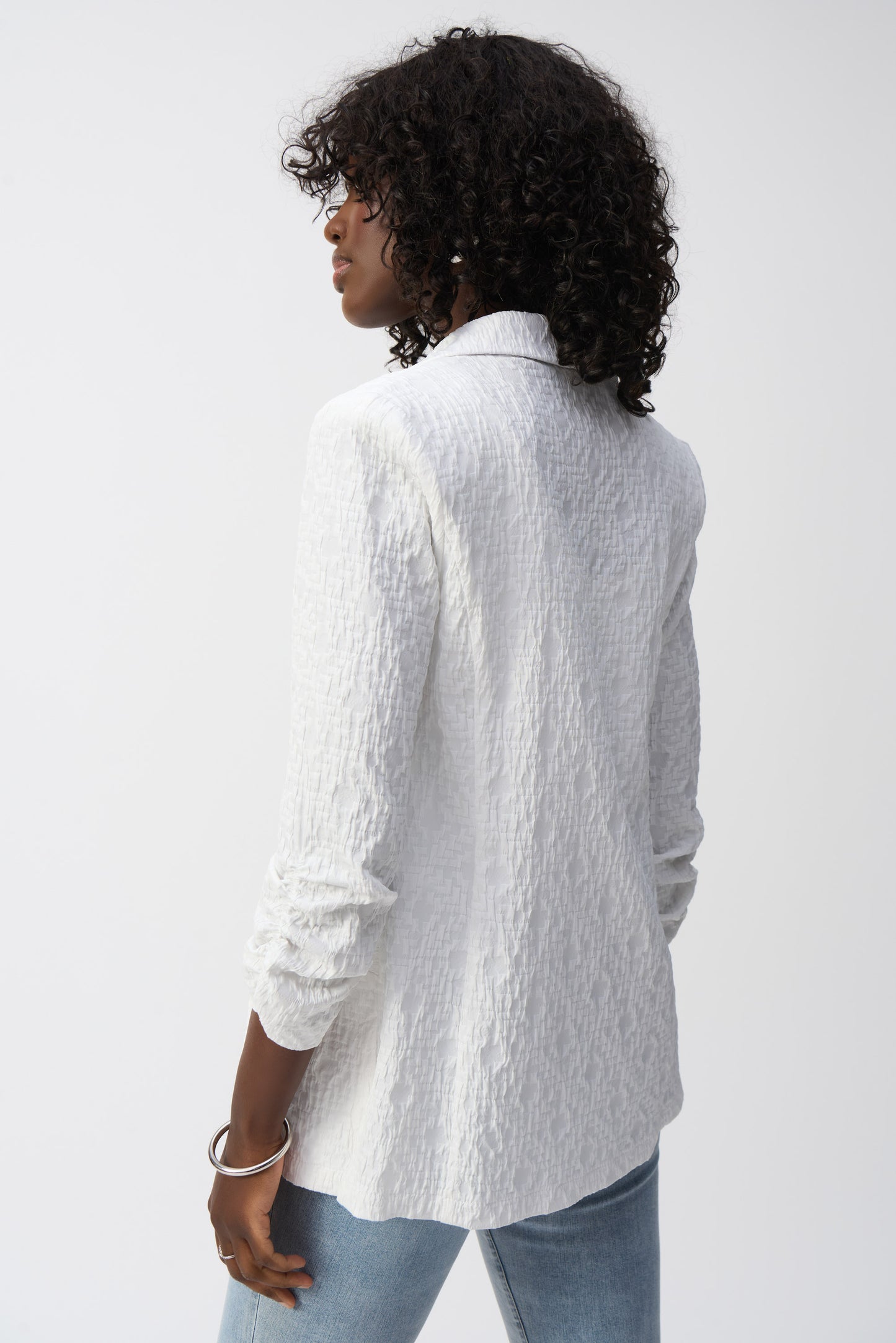 Pearls Boutique- Port Dover Ontario-Joseph Ribkoff White Textured Blazer 242034 Open-front jacket with a polished yet relaxed silhouette for effortless layering, featuring a sophisticated notched lapel for both office and casual wear. Designed with long, straight sleeves for versatile all-season styling. Functional side pockets add practicality without compromising style. Made from a soft, breathable blend of 99% polyester and 1% spandex for all-day comfort.