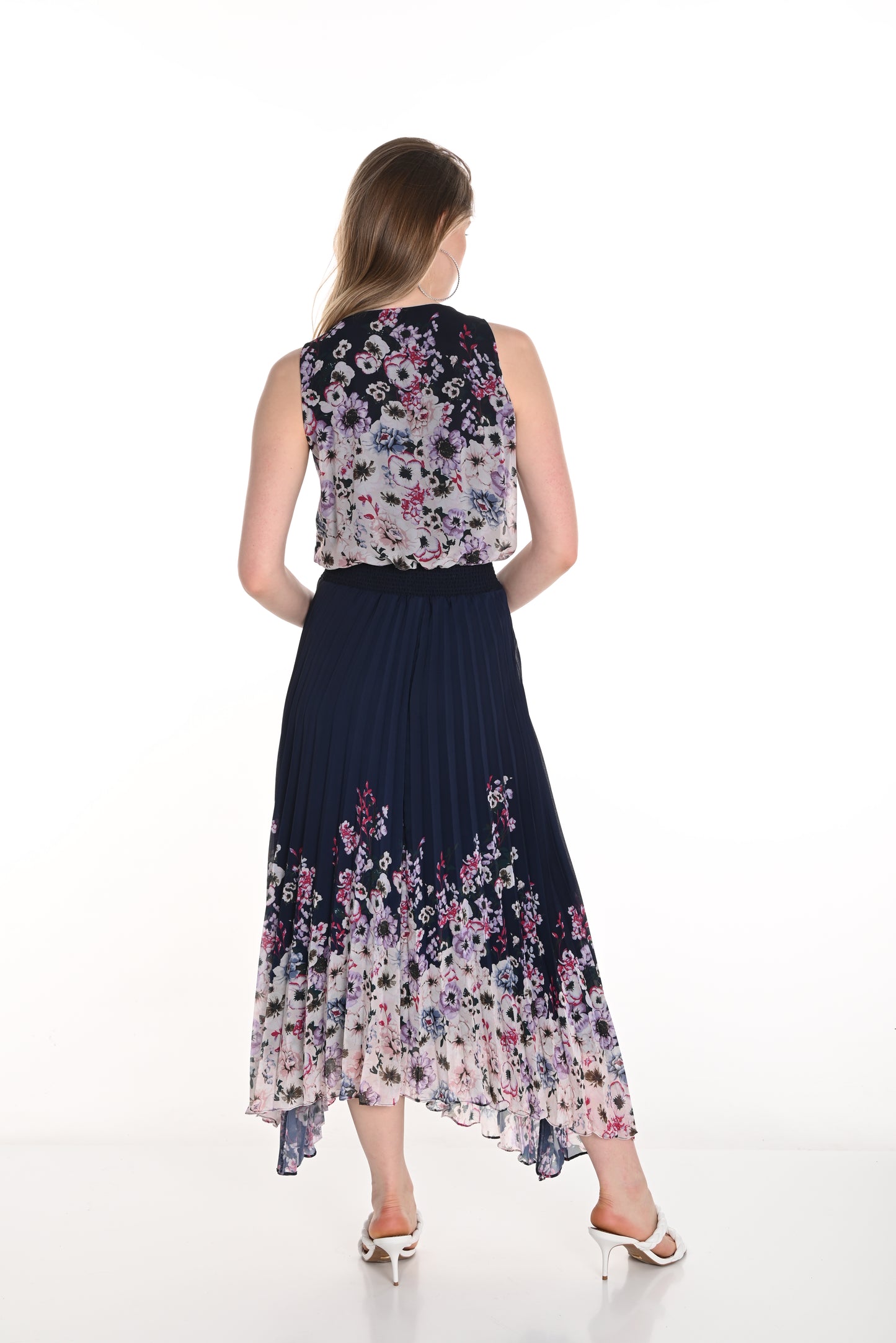 Pearls Boutique - Port Dover Ontario-Frank Lyman Floral Dress (Style 256712U) featuring a navy blue and blush floral pattern. This woven dress has a pleated skirt, relaxed fit, and flowing silhouette, v neckline, sleeveless,offering effortless elegance. Made from 100% polyester, it is lightweight and perfect for spring celebrations. Crafted in Canada