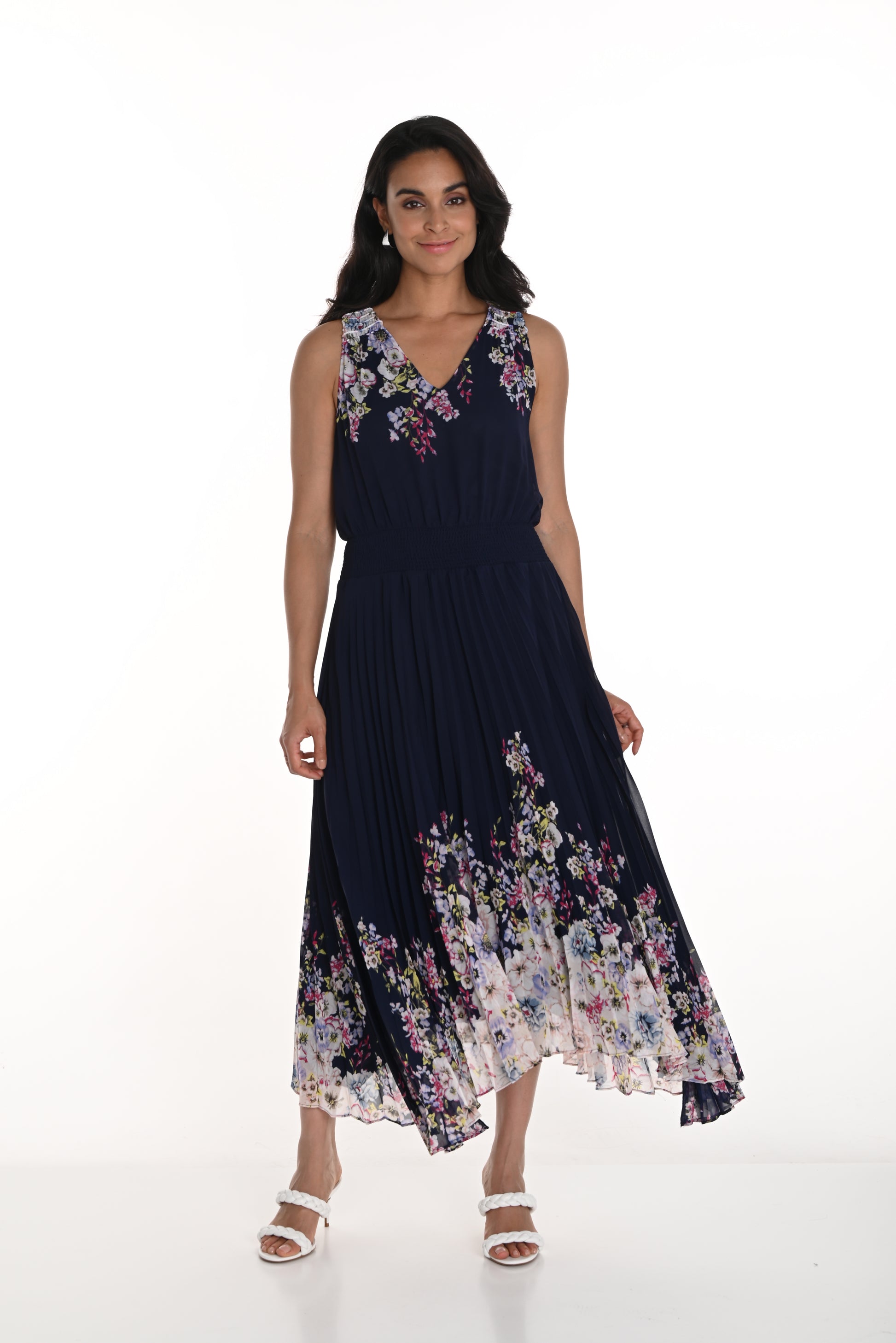 Pearls Boutique - Port Dover Ontario-Frank Lyman Floral Dress (Style 256712U) featuring a navy blue and blush floral pattern. This woven dress has a pleated skirt, relaxed fit, and flowing silhouette, v neckline, sleeveless,offering effortless elegance. Made from 100% polyester, it is lightweight and perfect for spring celebrations. Crafted in Canada