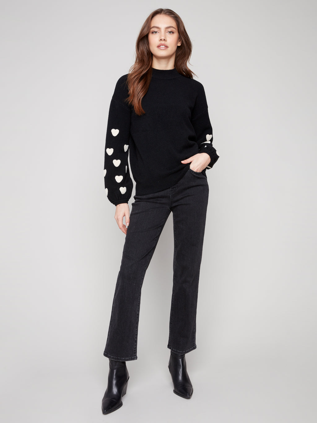 Pearls Boutique | Port Dover Ontario|Charlie B | Mock Neck Sweater With Embroidered Hearts| colour black with white embroidered hearts on sleeves. Mock neck sweater in a soft plush knit, featuring heart embroidery on balloon sleeves, relaxed fit.