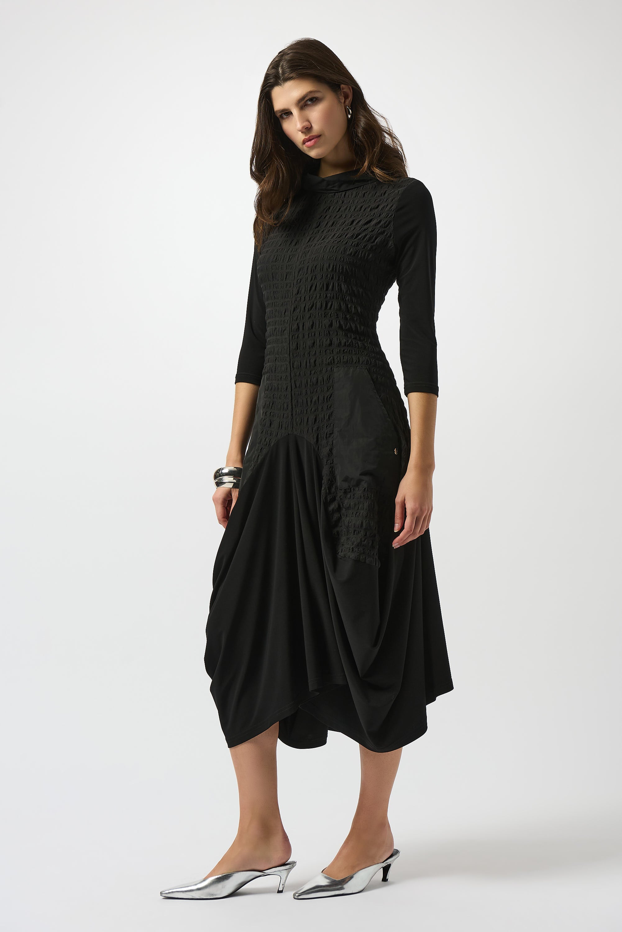 Pearls Boutique| Port Dover Ontario |Joseph Ribkoff | Bubble Jacquard  Silky Knit Cocoon Dress| colour black.
A-line silhouette with a fluid, graceful drape that flatters every movement
Silky knit base with luxe bubble jacquard and memory fabric accents for sculptural texture
Soft cowl neckline adds a touch of understated drama
Three-quarter sleeves designed to balance structure with effortless ease
Functional front pockets for a blend of chic style and everyday practicality
Back zipper closure