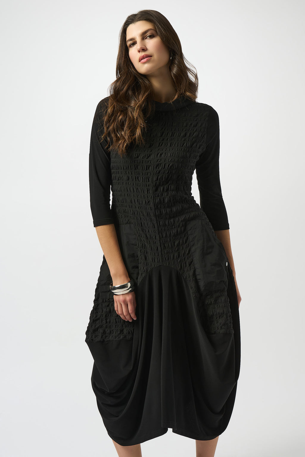 Pearls Boutique| Port Dover Ontario |Joseph Ribkoff | Bubble Jacquard  Silky Knit Cocoon Dress| colour black.
A-line silhouette with a fluid, graceful drape that flatters every movement
Silky knit base with luxe bubble jacquard and memory fabric accents for sculptural texture
Soft cowl neckline adds a touch of understated drama
Three-quarter sleeves designed to balance structure with effortless ease
Functional front pockets for a blend of chic style and everyday practicality
Back zipper closure