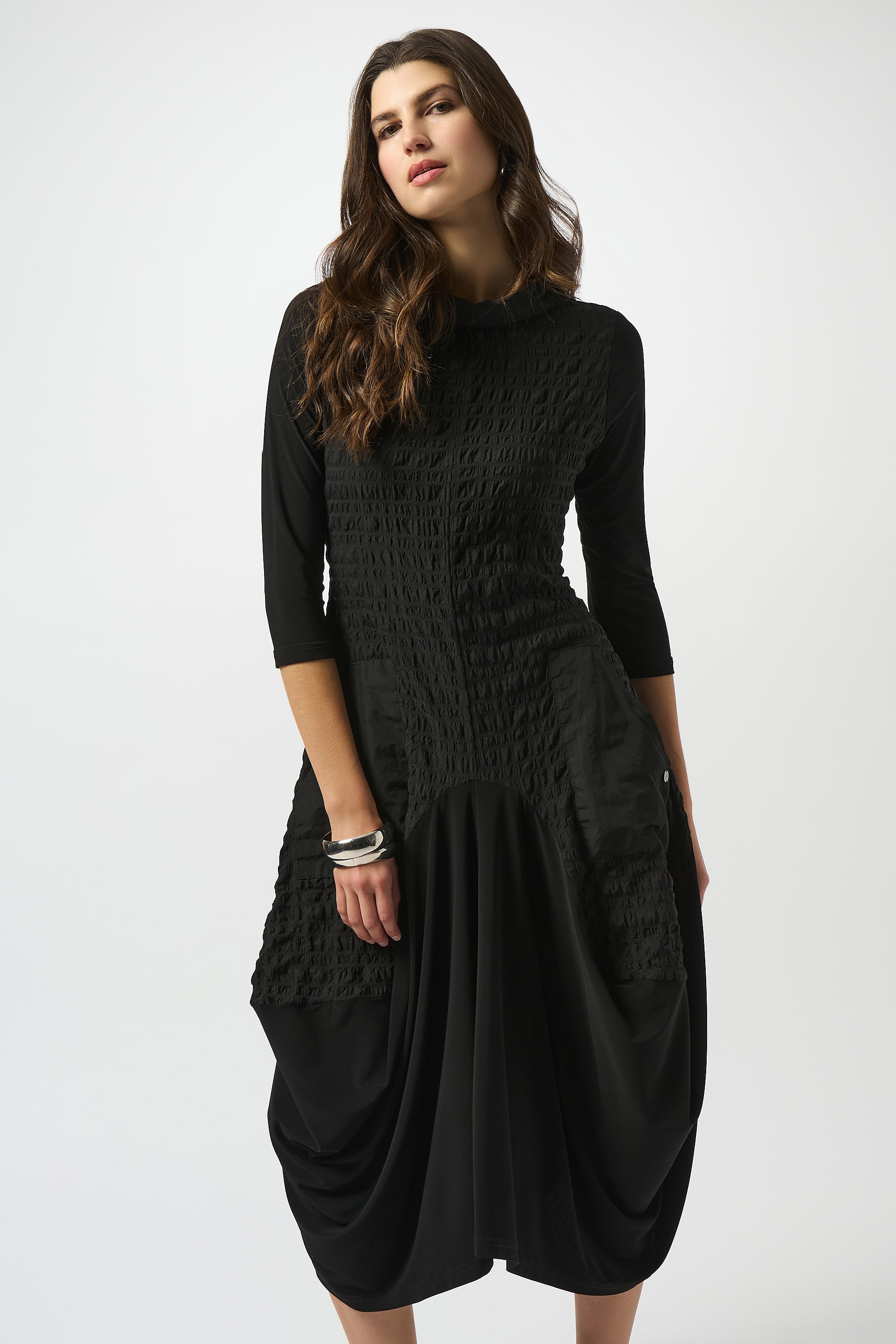Pearls Boutique| Port Dover Ontario |Joseph Ribkoff | Bubble Jacquard  Silky Knit Cocoon Dress| colour black.
A-line silhouette with a fluid, graceful drape that flatters every movement
Silky knit base with luxe bubble jacquard and memory fabric accents for sculptural texture
Soft cowl neckline adds a touch of understated drama
Three-quarter sleeves designed to balance structure with effortless ease
Functional front pockets for a blend of chic style and everyday practicality
Back zipper closure