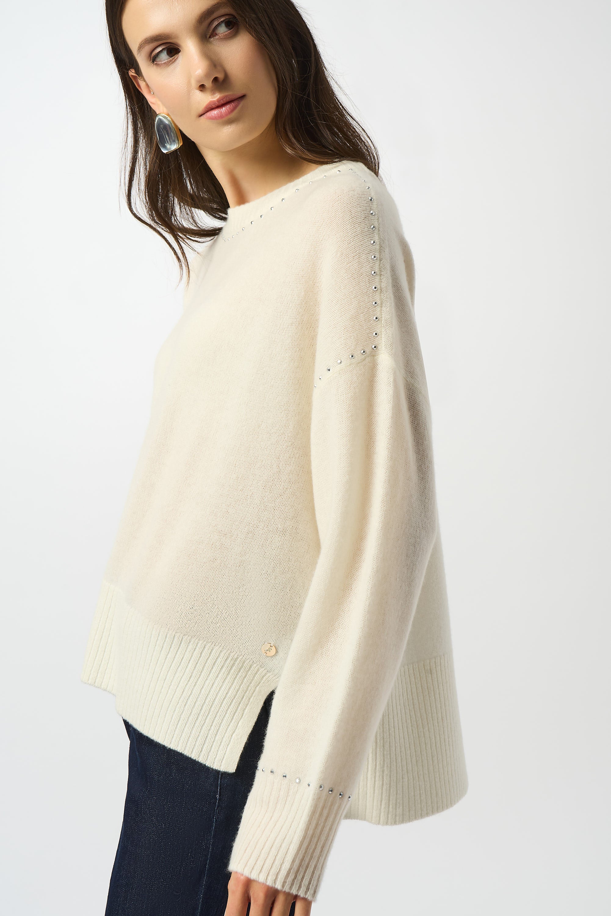 Pearls Boutique Port Dover Ontario Joseph Ribkoff Cashmere Crew Neck Top with Stud Detailing. 100% cashmere sweater with a classic crew neckline, long straight sleeves, and subtle stud detailing, crafted from ultra-soft, fine-grade cashmere for a luxurious and lightweight feel. Colour Winter White 

