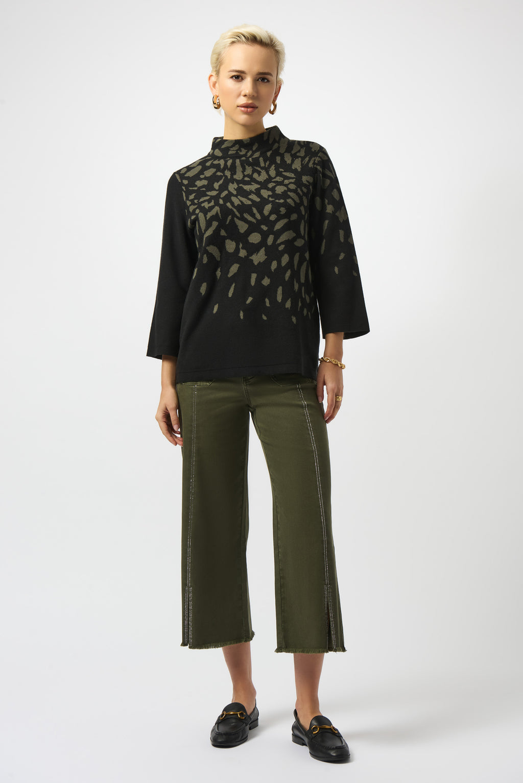 Pearls Boutique | Port Dover Ontario |Joseph Ribkoff |Jacquard Animal Print Sweater. Luxurious jacquard sweater knit with soft, breathable texture
Bold animal print in a dynamic Black/Avocado colourway
Mock neckline for an elevated, cozy silhouette
Three-quarter straight sleeves for a balanced, structured fit
Rhinestone detailing for a refined, touch-of-sparkle finish.