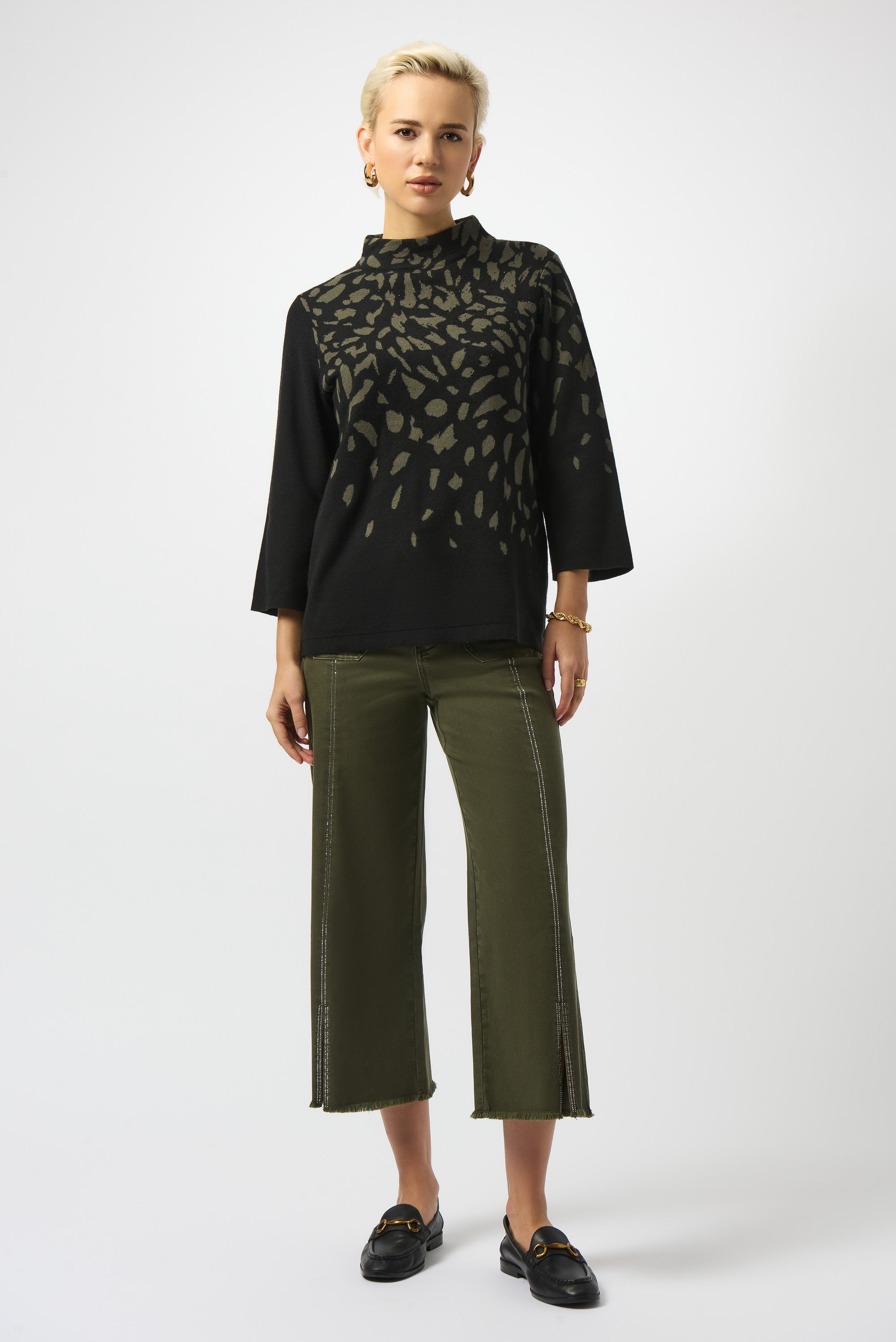 Pearls Boutique | Port Dover Ontario |Joseph Ribkoff |Jacquard Animal Print Sweater. Luxurious jacquard sweater knit with soft, breathable texture
Bold animal print in a dynamic Black/Avocado colourway
Mock neckline for an elevated, cozy silhouette
Three-quarter straight sleeves for a balanced, structured fit
Rhinestone detailing for a refined, touch-of-sparkle finish.