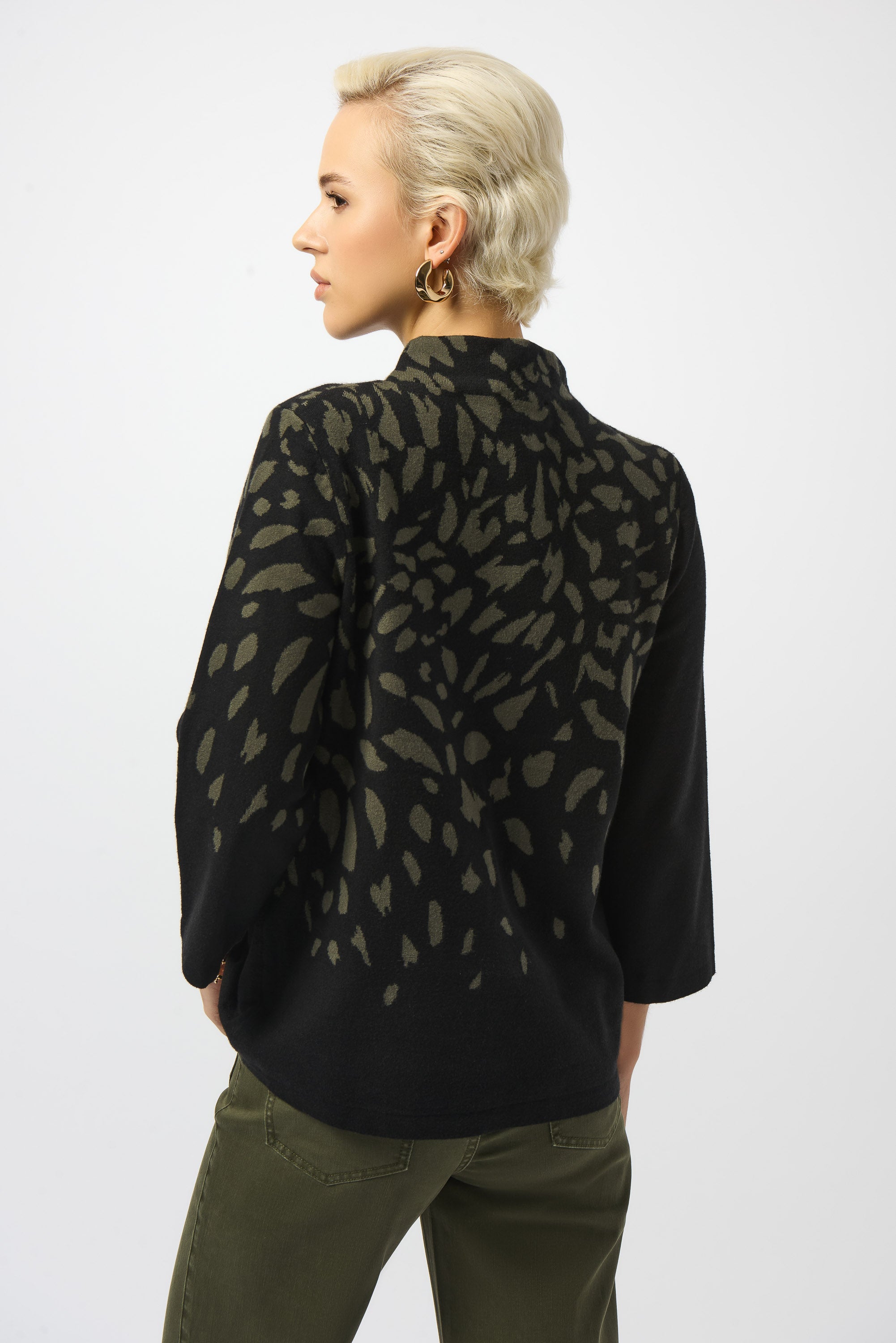 Pearls Boutique | Port Dover Ontario |Joseph Ribkoff |Jacquard Animal Print Sweater. Luxurious jacquard sweater knit with soft, breathable texture
Bold animal print in a dynamic Black/Avocado colourway
Mock neckline for an elevated, cozy silhouette
Three-quarter straight sleeves for a balanced, structured fit
Rhinestone detailing for a refined, touch-of-sparkle finish.