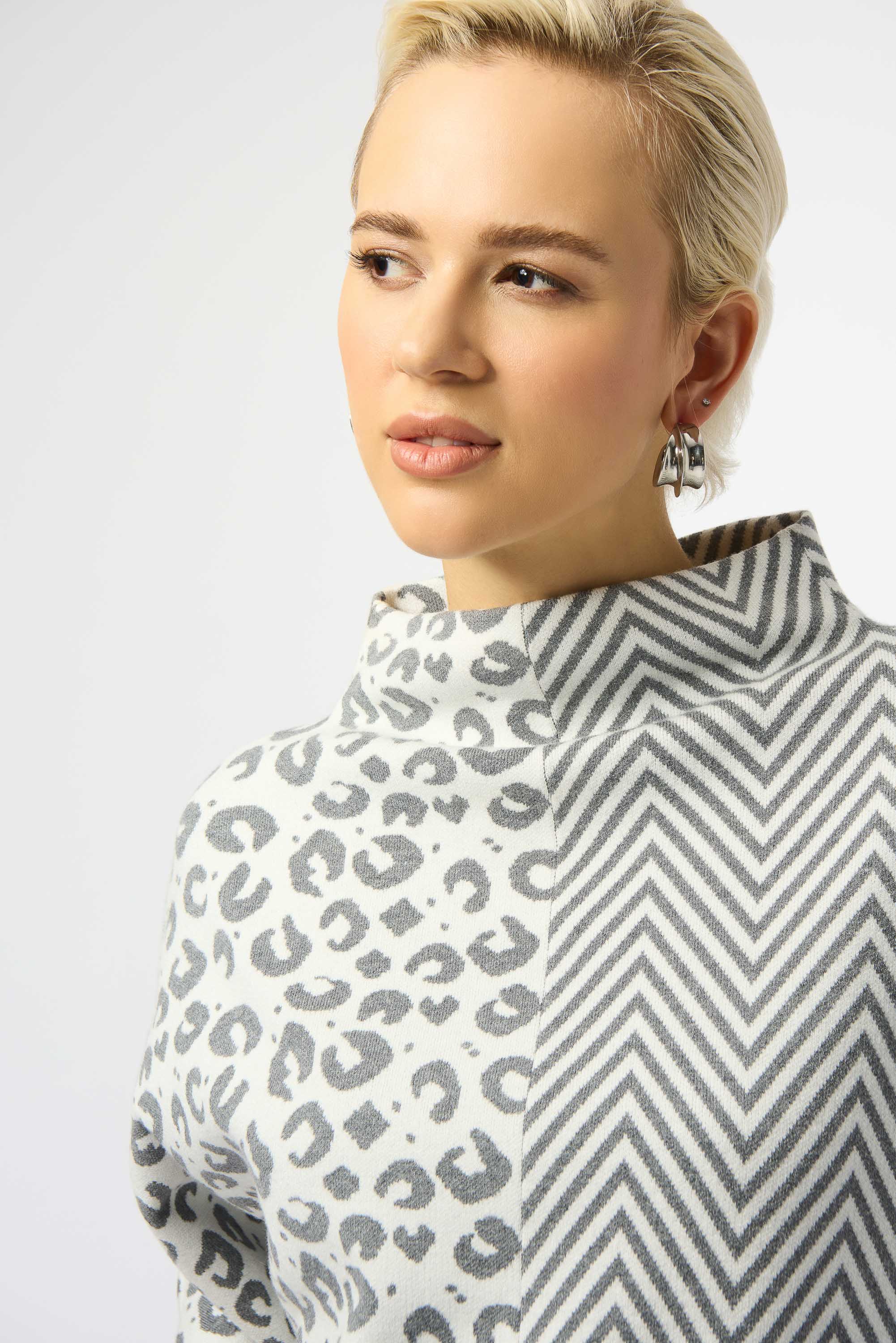 Pearls Boutique Port Dover Ontario Joseph Ribkoff Jacquard Knit Mixed Print Boxy Sweater 253981-3653 
Jacquard sweater top in soft light grey and winter white, featuring a bold half animal print and half herringbone design, with a funnel neck, relaxed boxy silhouette, and three-quarter dolman sleeves, crafted from a luxurious viscose-rich knit for a soft, textured feel.