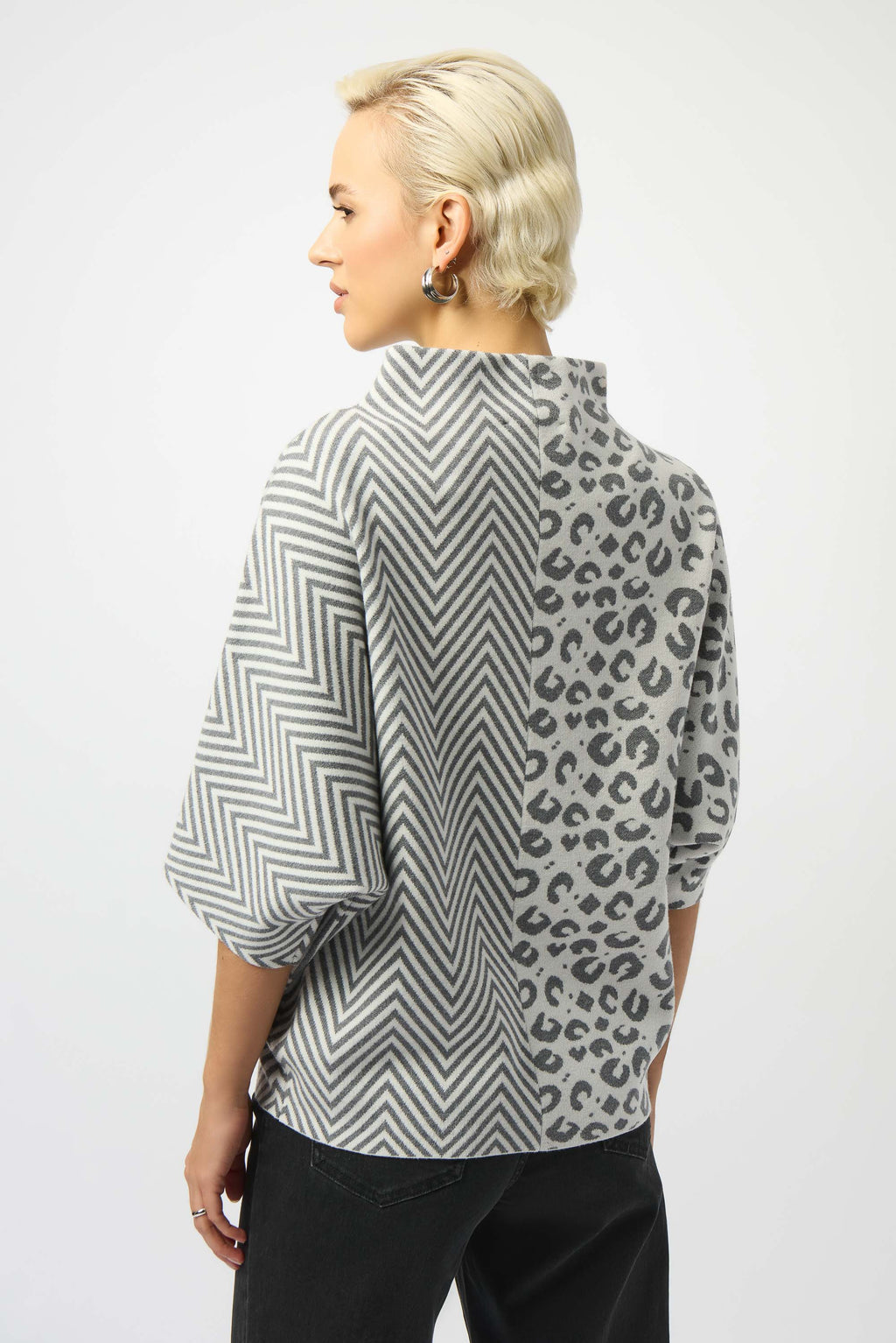 Pearls Boutique Port Dover Ontario Joseph Ribkoff Jacquard Knit Mixed Print Boxy Sweater 253981-3653 
Jacquard sweater top in soft light grey and winter white, featuring a bold half animal print and half herringbone design, with a funnel neck, relaxed boxy silhouette, and three-quarter dolman sleeves, crafted from a luxurious viscose-rich knit for a soft, textured feel.