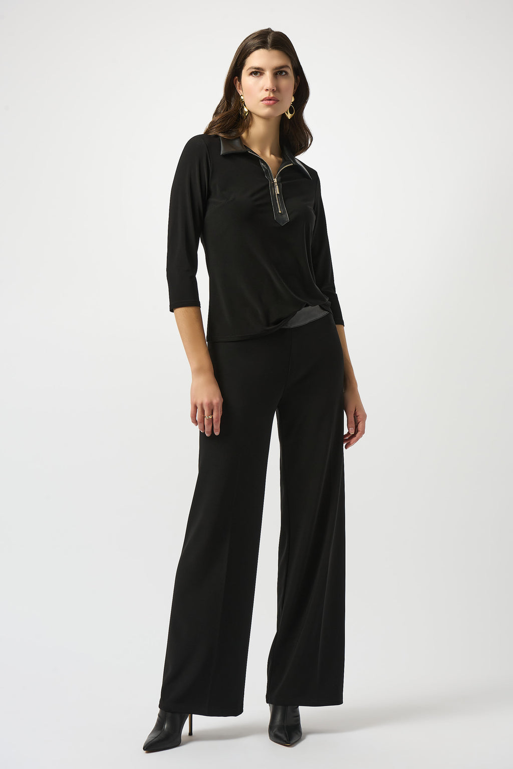 Pearls Boutique Port Dover Ontario Joseph Ribkoff Silky Knit and Leatherette Fitted Top. colour Black Fitted silhouette designed to contour and flatter
Silky knit fabric with a soft, fluid feel
Bold shirt collar with leatherette detailing for modern sophistication
Front placket with zipper accent for a sleek, contemporary edge
Three-quarter sleeves offering a balanced, polished look
Unlined for lightweight, effortless wear