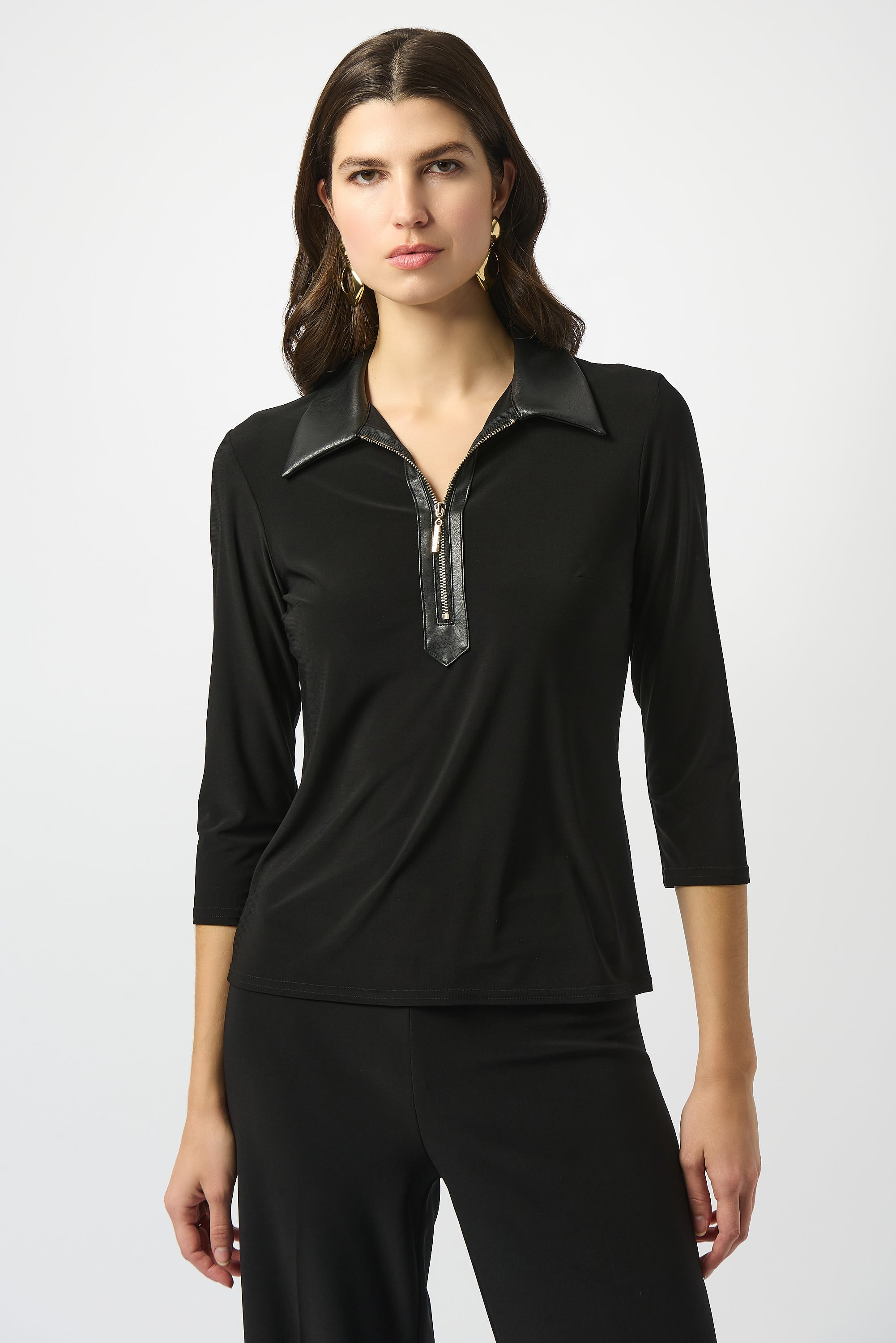 Pearls Boutique Port Dover Ontario Joseph Ribkoff Silky Knit and Leatherette Fitted Top. colour Black Fitted silhouette designed to contour and flatter
Silky knit fabric with a soft, fluid feel
Bold shirt collar with leatherette detailing for modern sophistication
Front placket with zipper accent for a sleek, contemporary edge
Three-quarter sleeves offering a balanced, polished look
Unlined for lightweight, effortless wear