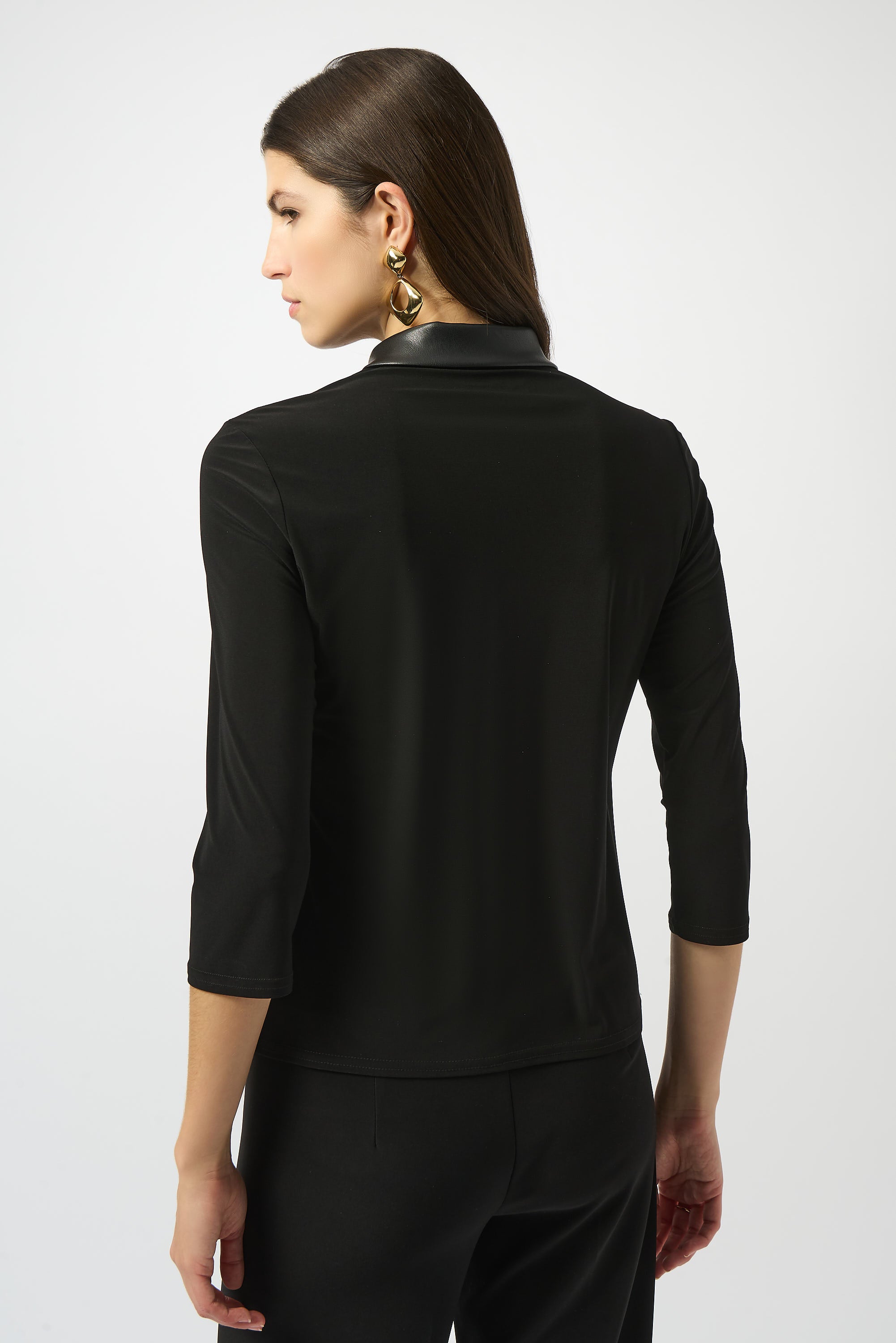 Pearls Boutique Port Dover Ontario Joseph Ribkoff Silky Knit and Leatherette Fitted Top. colour Black Fitted silhouette designed to contour and flatter
Silky knit fabric with a soft, fluid feel
Bold shirt collar with leatherette detailing for modern sophistication
Front placket with zipper accent for a sleek, contemporary edge
Three-quarter sleeves offering a balanced, polished look
Unlined for lightweight, effortless wear
