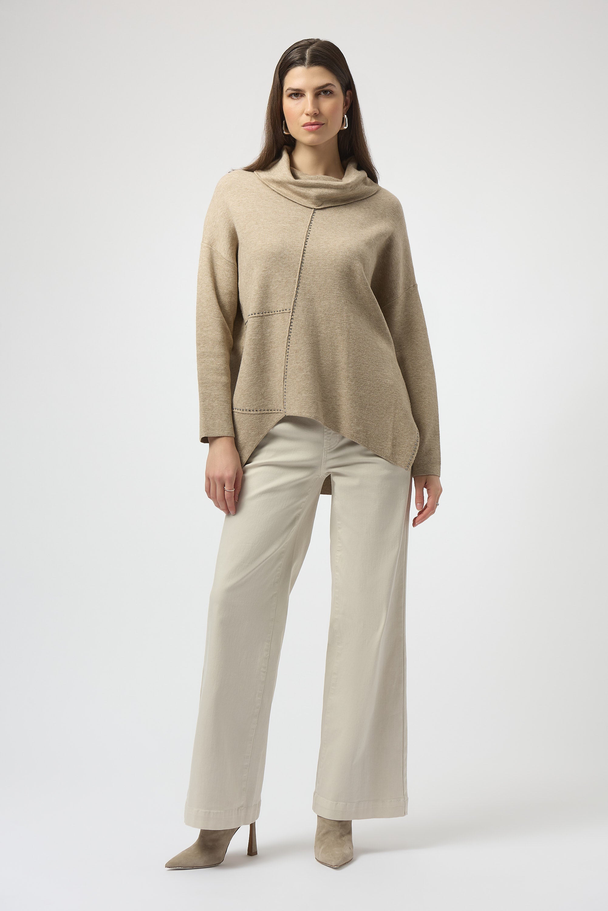 Pearls Boutique| Port Dover Ontario| Joseph Ribkoff |Sweater Knit Oatmeal melange | tunic length sweater. Soft sweater knit with a breathable, luxe texture
 cowl neckline for a cozy and refined drape
Asymmetrical design with hi-low hem for modern movement
Long straight sleeves offering clean, elegant lines
Rhinestone iron-on detailing for a subtle shimmer

FABRIC & FIT
Crafted from a premium blend of viscose, polyamide, and polyester, this pullover ensures a soft hand-feel with a lightweight warmth.

