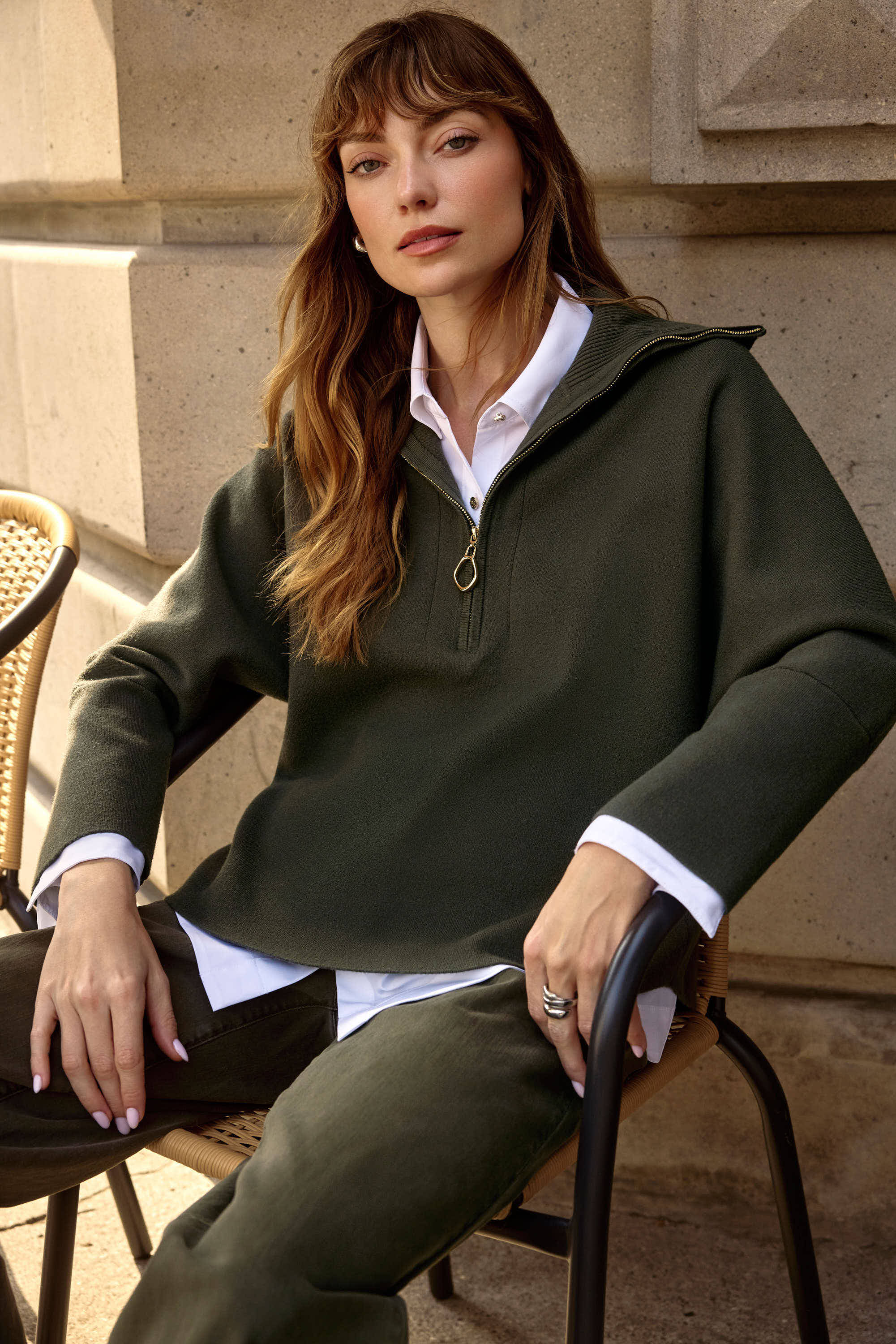 Pearls Boutique Port Dover Ontario Joseph_Ribkoff_Sweater_Knit_Boxy_Pullover_With_Zipped_Collar_253963-Soft sweater knit pullover with a relaxed boxy fit, featuring a modern zipped front neckline and elegant three-quarter bell sleeves that add graceful movement to the silhouette. colour Avocado Green.

