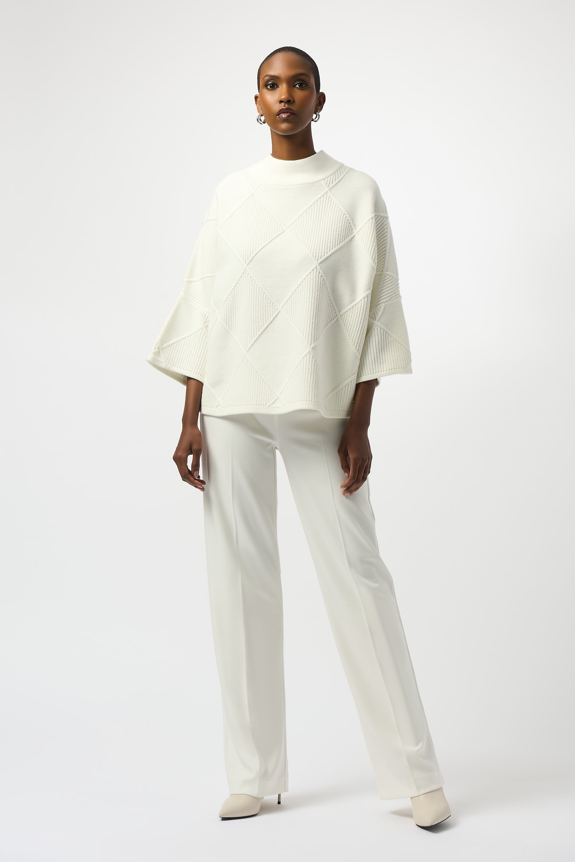 Pearls Boutique Port Dover Ontario Joseph Ribkoff Textured Sweater Knit Mock Neck Pullover 253943
Premium sweater knit with an intricate diamond texture
Mock collar for a modern, streamlined neckline
Long bell sleeves for elegant drape and fluid movement
Tailored fit with a soft, comfortable feel

Made from a rich blend of viscose, polyester, and nylon, this sweater offers a soft hand-feel with breathable warmth.