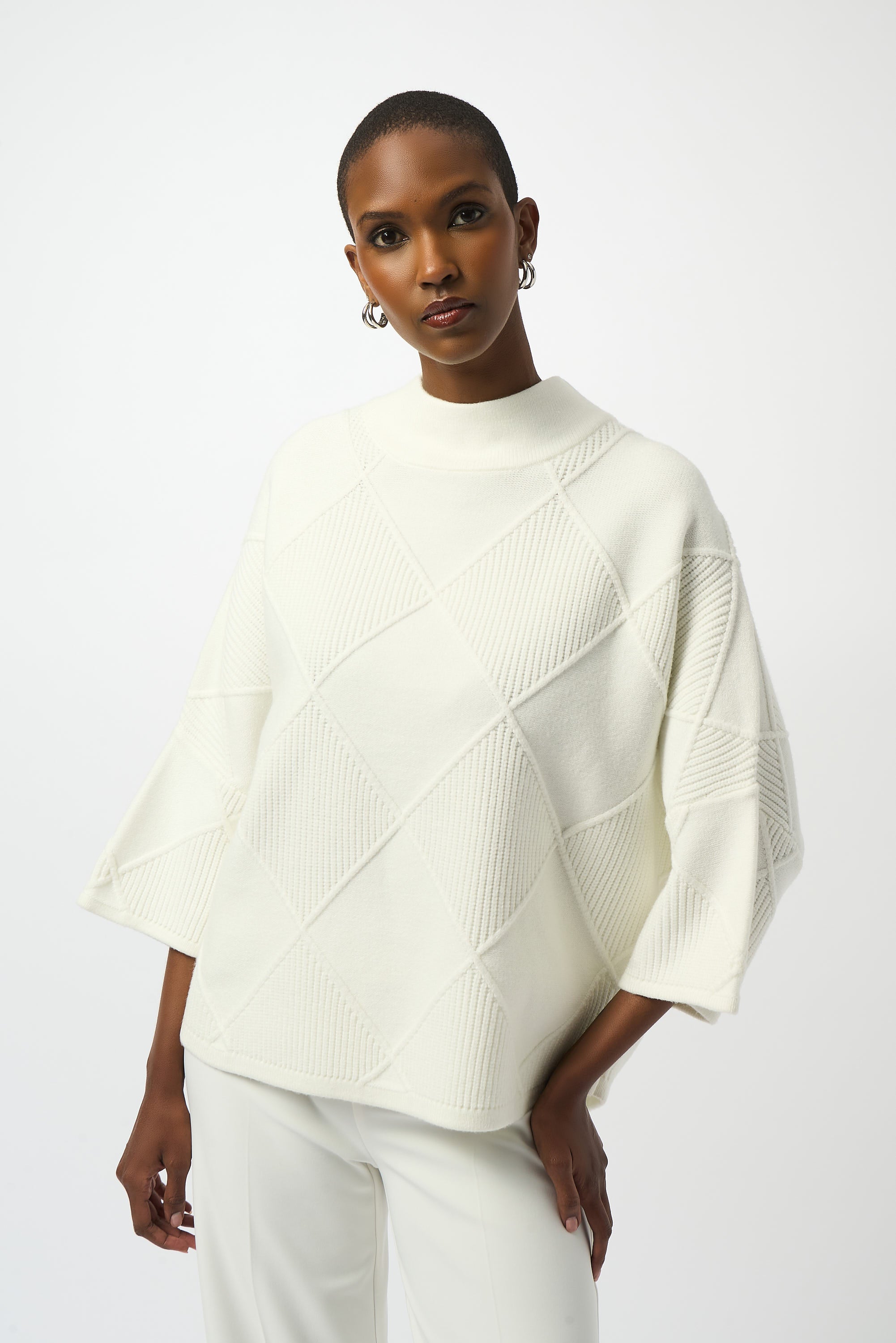 Pearls Boutique Port Dover Ontario Joseph Ribkoff Textured Sweater Knit Mock Neck Pullover 253943
Premium sweater knit with an intricate diamond texture
Mock collar for a modern, streamlined neckline
Long bell sleeves for elegant drape and fluid movement
Tailored fit with a soft, comfortable feel

Made from a rich blend of viscose, polyester, and nylon, this sweater offers a soft hand-feel with breathable warmth.