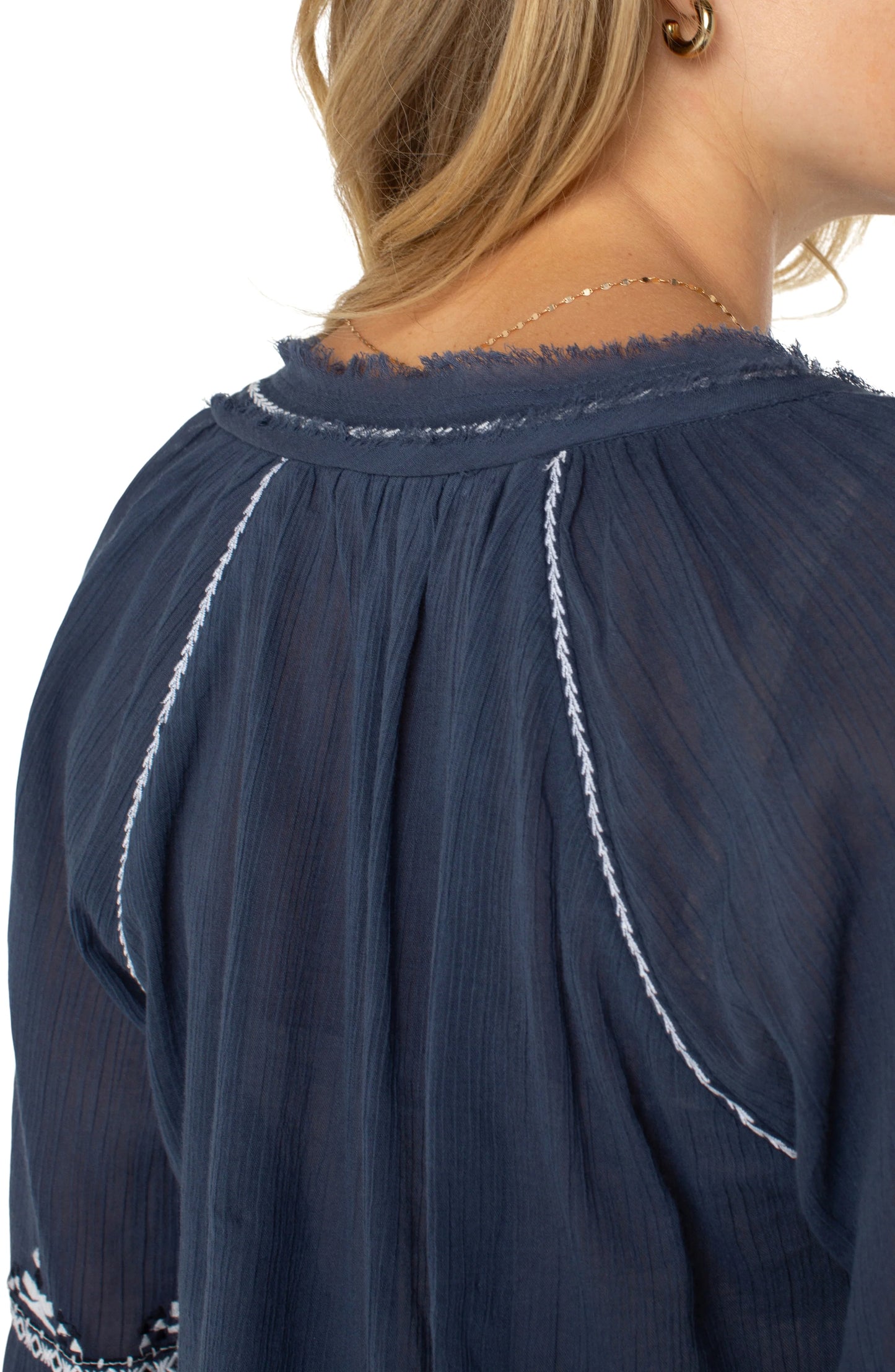 Pearls Boutique| Port Dover Ontario| Liverpool |  Longsleeve Raglan Woven Blouse|LM8F83WV57E1 A dark dusty blue embroidered woven top featuring white embroidery along the raglan sleeves and V-neckline. The top has long raglan sleeves, a V-neck design, and a relaxed, lightweight fit made from 100% cotton