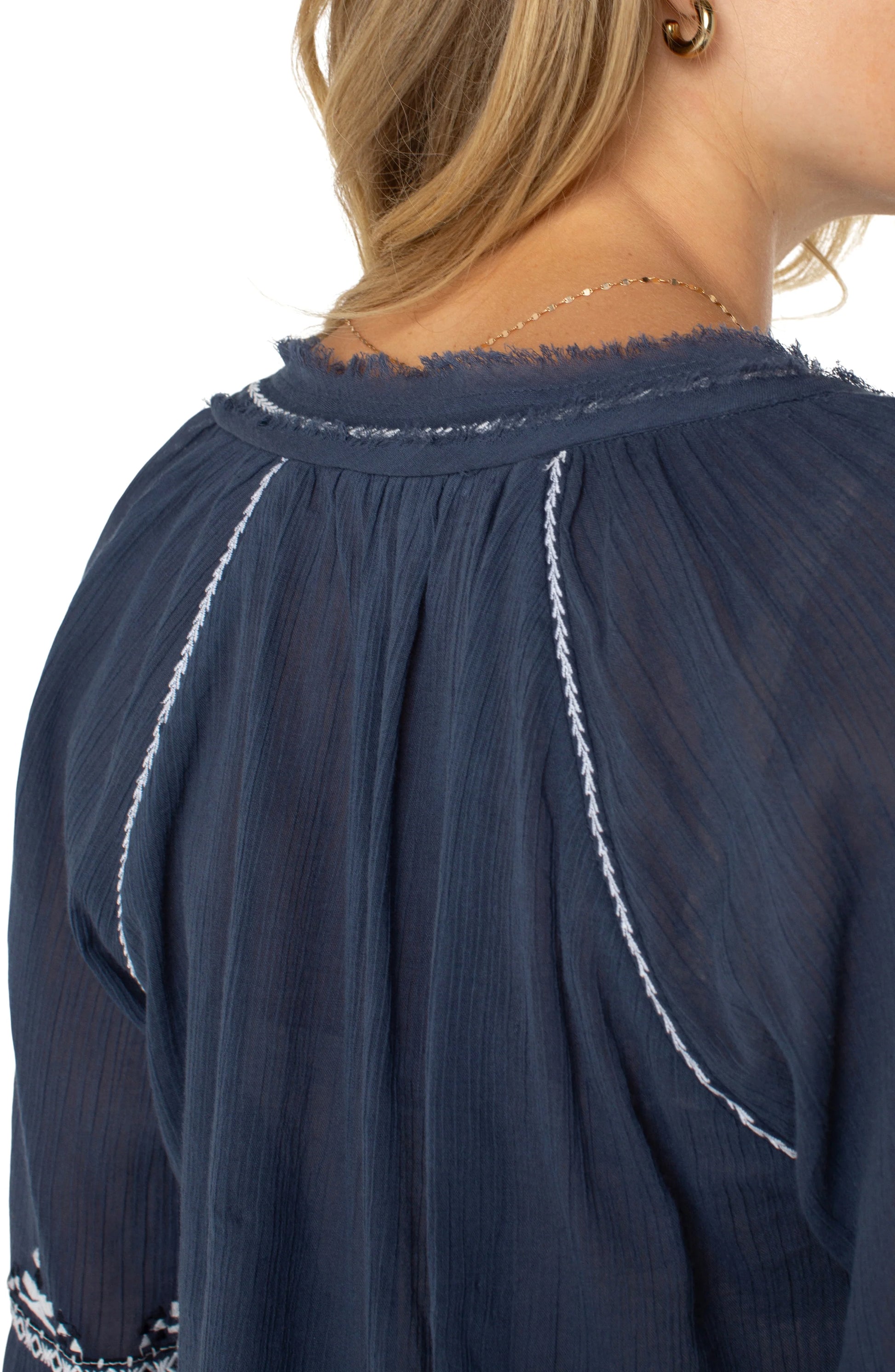 Pearls Boutique| Port Dover Ontario| Liverpool |  Longsleeve Raglan Woven Blouse|LM8F83WV57E1 A dark dusty blue embroidered woven top featuring white embroidery along the raglan sleeves and V-neckline. The top has long raglan sleeves, a V-neck design, and a relaxed, lightweight fit made from 100% cotton