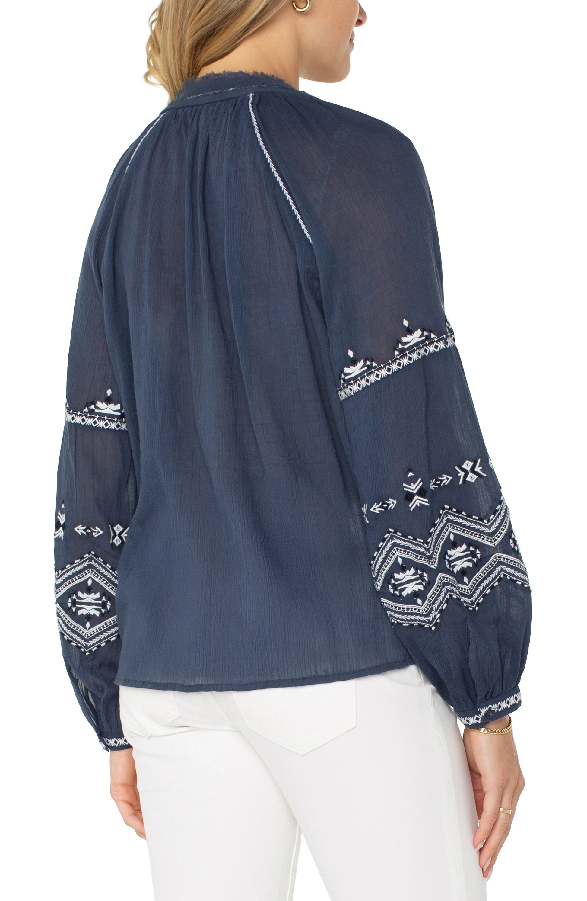 Pearls Boutique| Port Dover Ontario| Liverpool |  Longsleeve Raglan Woven Blouse|LM8F83WV57E1 A dark dusty blue embroidered woven top featuring white embroidery along the raglan sleeves and V-neckline. The top has long raglan sleeves, a V-neck design, and a relaxed, lightweight fit made from 100% cotton