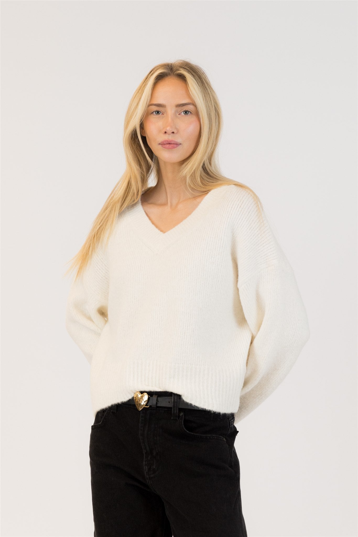 Pearls Boutique | Port Dover Ontario|Lyla + Lux | Eco-Conscious V-Neck Pullover Sweater| colour Ivory.Lyla + Lux women’s V-neck pullover sweater crafted from an eco-conscious blend of recycled polyester, acrylic, polyamide, wool, and elastane. Features a classic V-neckline, long sleeves, and a relaxed fit for effortless layering. The lightweight yet cozy knit offers breathability and softness, 
