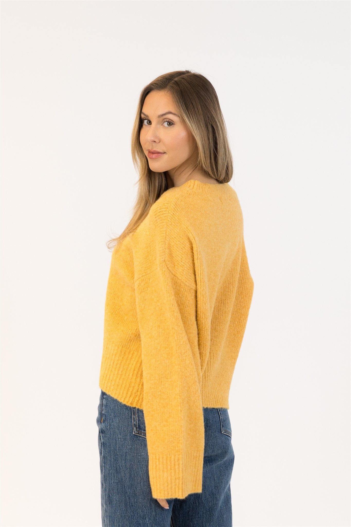 Pearls Boutique|Port Dover Ontario|Lyla + Lux | Eva Crewneck Pullover Sweater| Colour Gold.Lyla + Lux women’s eco-friendly crewneck pullover sweater crafted from a sustainable blend of recycled polyester, acrylic, polyamide, wool, and elastane. Features a classic crew neckline, long sleeves, and a relaxed yet feminine fit. The soft, breathable knit offers cozy comfort while maintaining a lightweight feel, making it ideal for layering or wearing on its own for a polished casual look.

