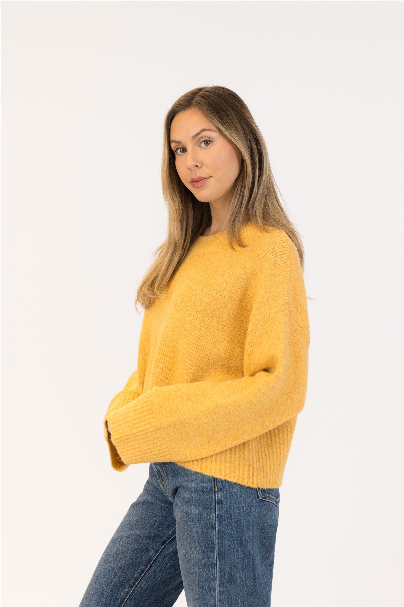 Pearls Boutique|Port Dover Ontario|Lyla + Lux | Eva Crewneck Pullover Sweater| Colour Gold.Lyla + Lux women’s eco-friendly crewneck pullover sweater crafted from a sustainable blend of recycled polyester, acrylic, polyamide, wool, and elastane. Features a classic crew neckline, long sleeves, and a relaxed yet feminine fit. The soft, breathable knit offers cozy comfort while maintaining a lightweight feel, making it ideal for layering or wearing on its own for a polished casual look.

