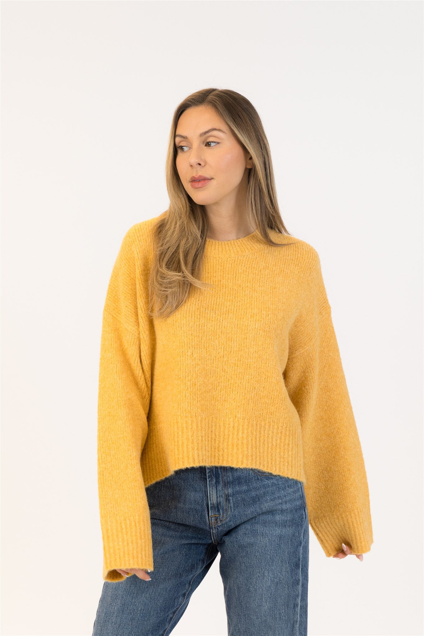 Pearls Boutique|Port Dover Ontario|Lyla + Lux | Eva Crewneck Pullover Sweater| Colour Gold.Lyla + Lux women’s eco-friendly crewneck pullover sweater crafted from a sustainable blend of recycled polyester, acrylic, polyamide, wool, and elastane. Features a classic crew neckline, long sleeves, and a relaxed yet feminine fit. The soft, breathable knit offers cozy comfort while maintaining a lightweight feel, making it ideal for layering or wearing on its own for a polished casual look.

